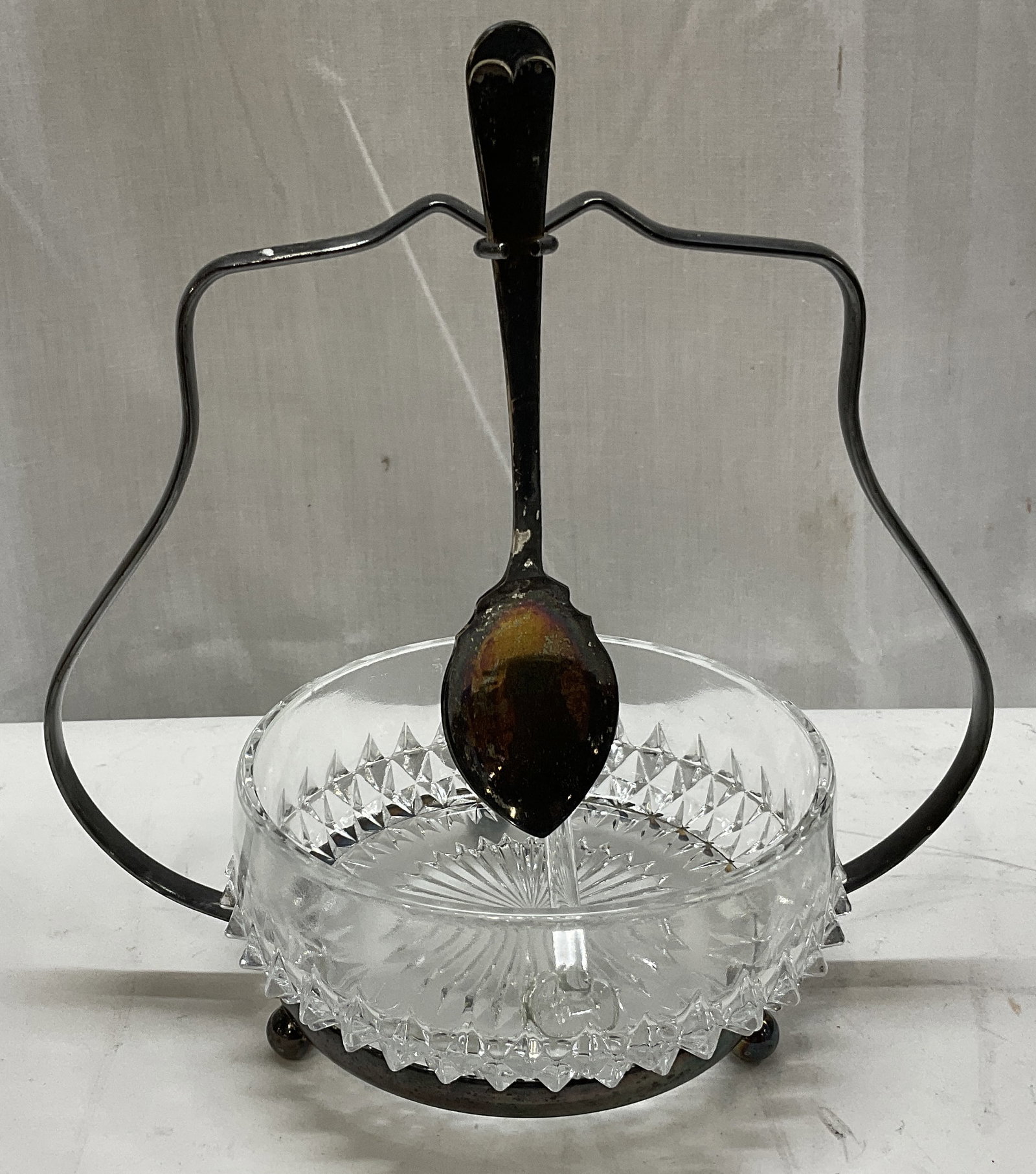 MID-CENTURY MODERN Brama Condiment Serving Set ENG: Mid-Century Modern Brama Condiment Serving Set. Features a Cut Diamond-Point Hobnail Glass Bowl in a Silver-Plated Arched Holder. Holds Silver-Plated Spoon. Made in England. Comes with Small Glass Spo