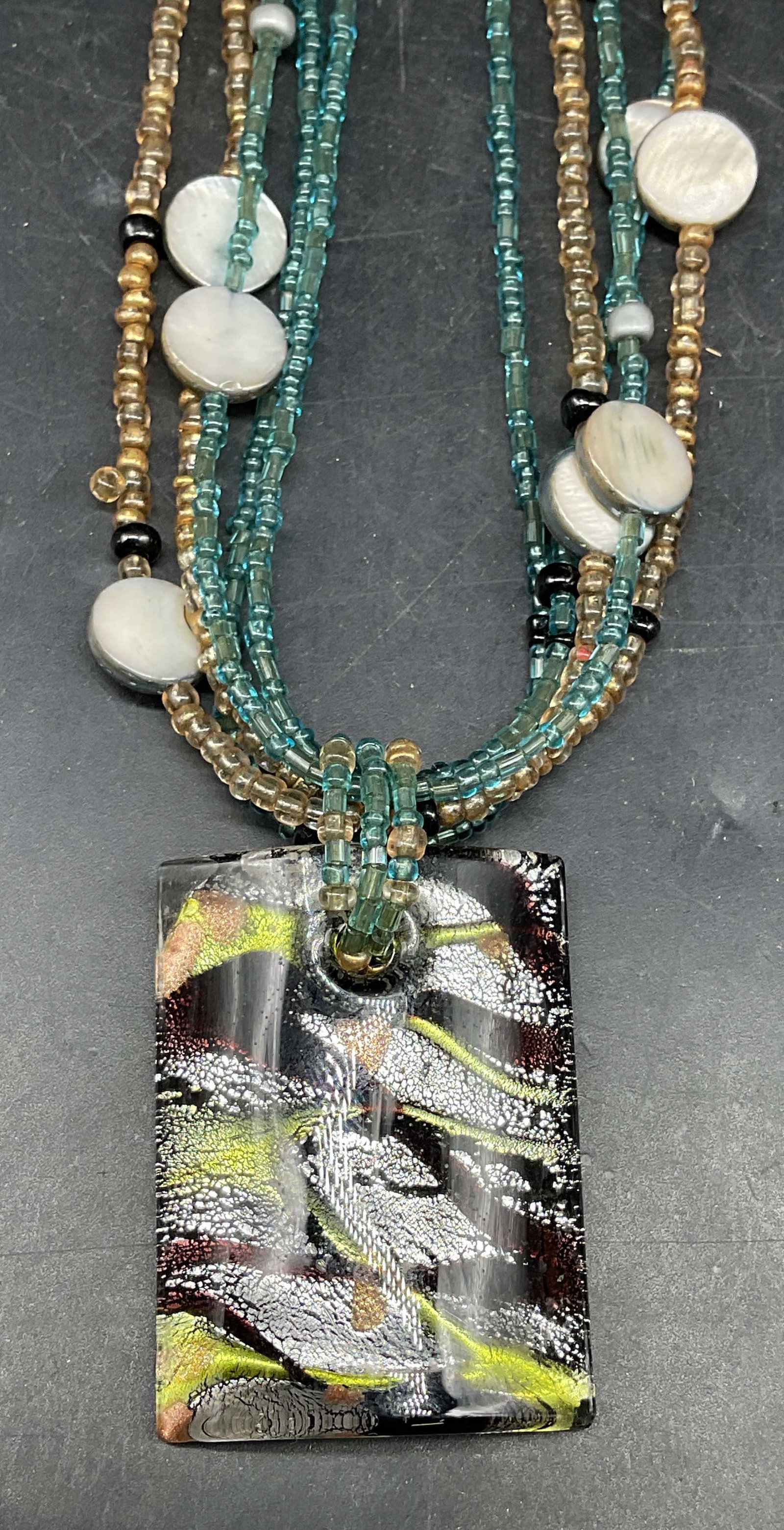 CG MOP Bead Art Glass Pendant Necklace: CG blue and gold seed beaded multi strand necklace its mother of pearl beads and art glass pendant. Drop length 10 inches. Some scratching. Jewelry, estate jewelry, costume jewelry, cocktail jewelry, 