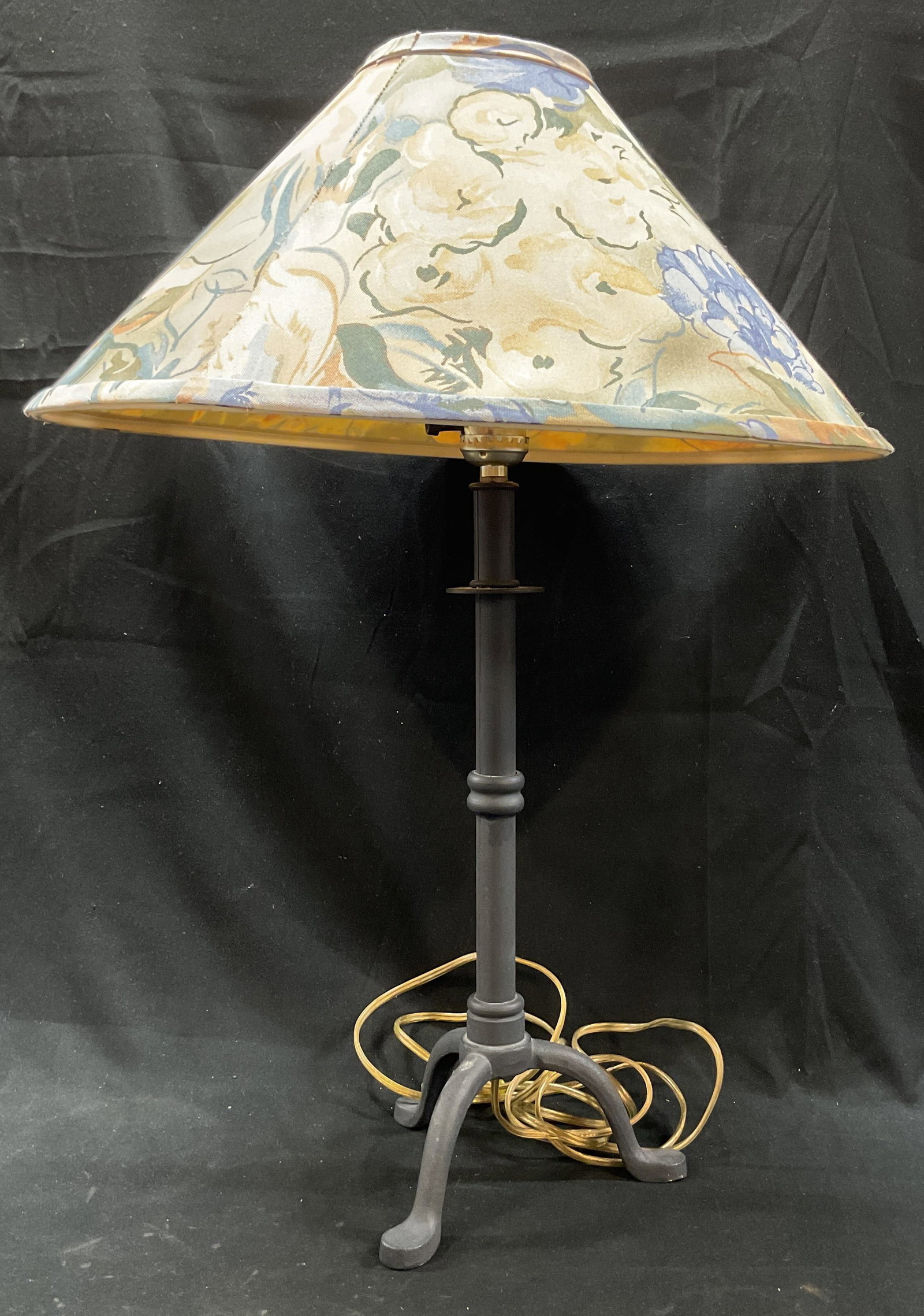 Vintage Cast Iron Tripod Table Lamp W Floral Shade: Vintage cast iron tripod table lamp. Comes with floral fabric shade in varying colors. Footed base, three tripod legs. Measures ht approx 23 inches diam approx 7 inches. Not tested for function, sold
