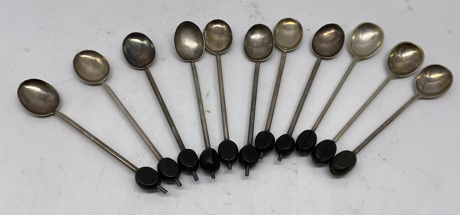 St11 VTG Art Deco Coffee Bean Spoons: Set of 11 Vintage Art Deco Coffee Bean Spoons. Silver-Plated with Black Coffee Bean Accent. Scratching and Tarnishing Present. Measures app 4in H x 0.5in W. Vintage, Art Deco, Coffee Bean, Tiny