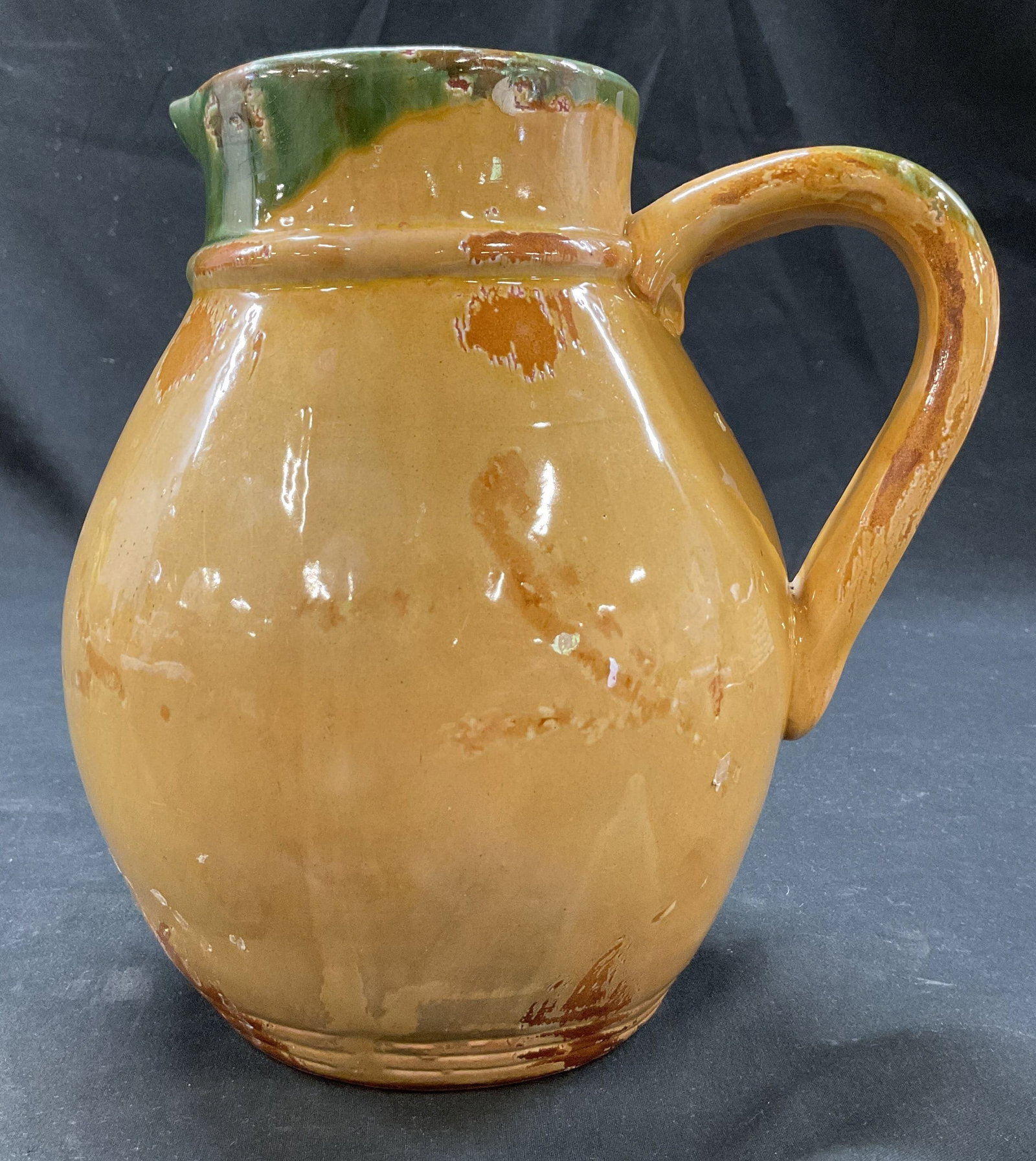 Vintage Yellow Glaze Ceramic Pitcher: Vintage yellow glaze ceramic pitcher. Bulbous body. Hints of green glaze. Measures ht approx 8.5 inches diam approx 4 inches. Crazing. Pitcher, tableware, home decor, table decor, decor, home