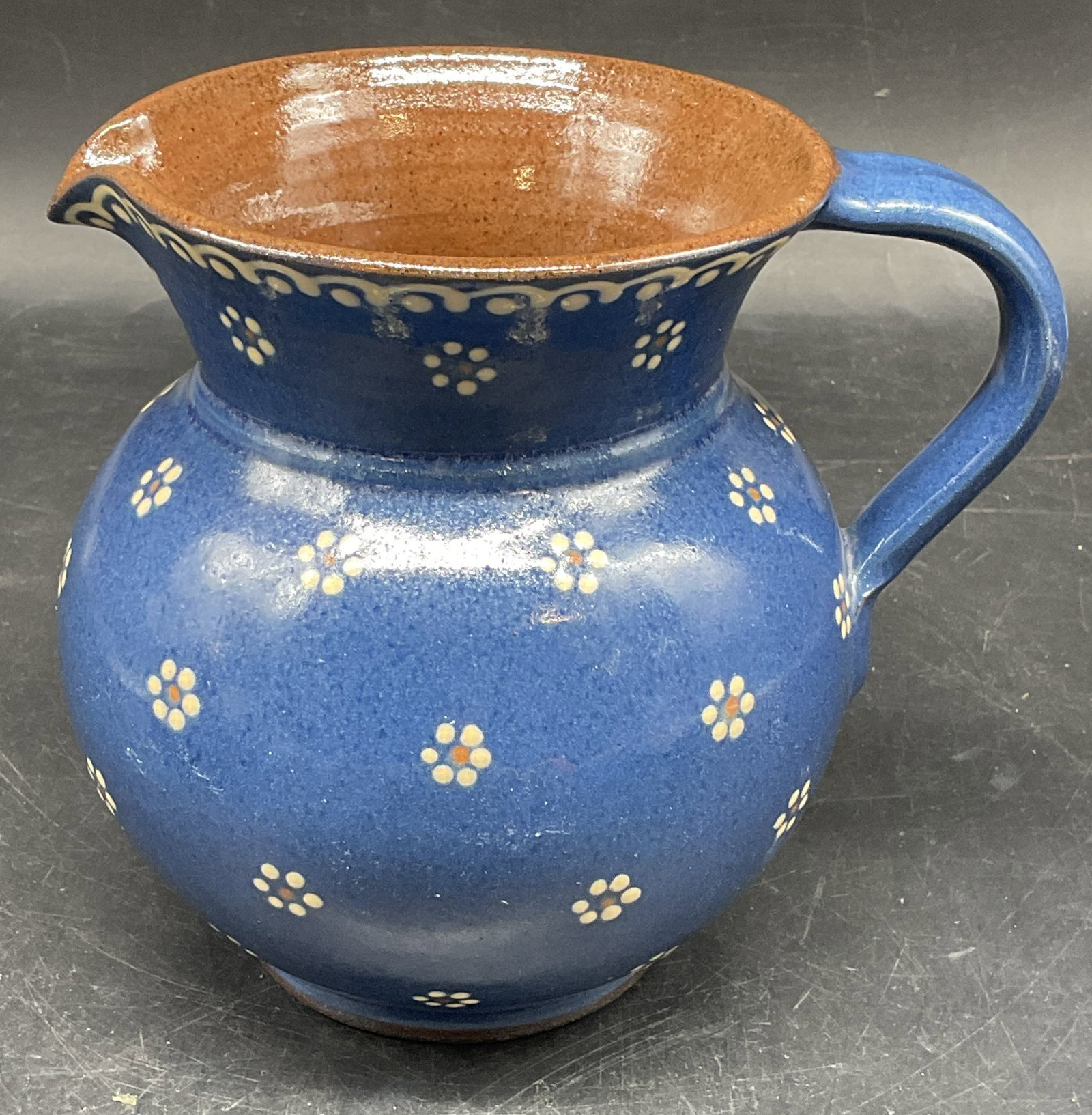 Vintage Signed Blue Floral Pottery Pitcher: Vintage signed blue floral pottery pitcher. Hand painted. Measures approx. 5.75 x 4.5 x 5.5 inches. Small chip. Pottery pitcher, blue pitcher, floral pitcher, tableware, table accessories, homewares,
