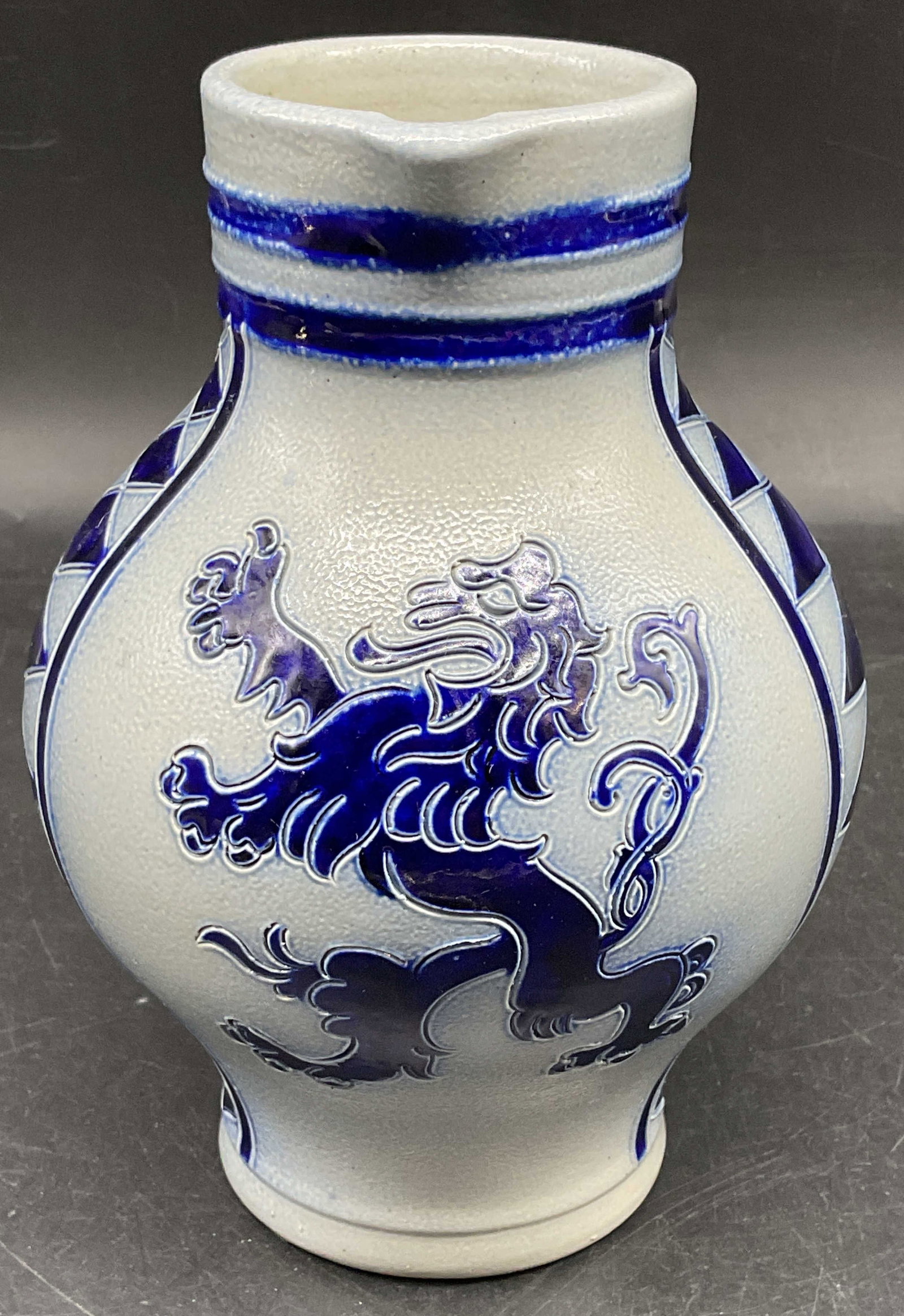 Merkelbach Salt Glazed Stoneware Pitcher Germany: Vintage Merkelbach cobalt blue salt glazed stoneware pitcher with Lion motif. Measures approx. 5 x 7.25 inches. Made in Germany. Some scratching. Merkelbach pitcher, salt glazed stoneware pitcher,