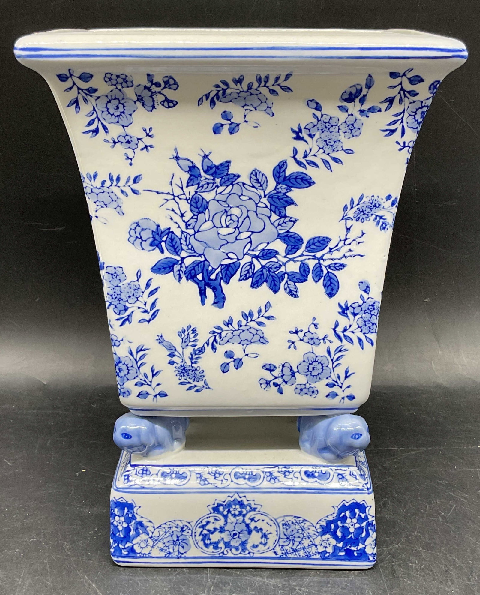 Andrea by Sadek Porcelain Chinoiserie Vase: Andrea by Sadek blue and white porcelain chinoiserie vase with floral motif and foo dog feet. Measures approx. 6.75 x 5.25 x 9.5 inches. Some scratching. Andrea by Sadek vase, porcelain vase, chinoise