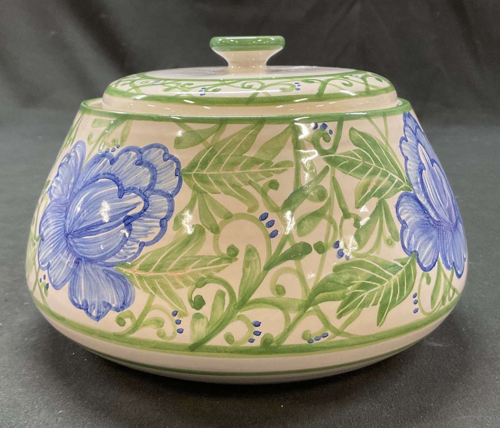 Vintage Ceramic Hand Painted Lidded Jar: Vintage ceramic hand painted lidded jar. Signed Angela on underside. Hand painted scroll and floral motifs in blue and green. Glossy finish. Measures ht approx 4.5 inches diam approx 5 inches. Surface