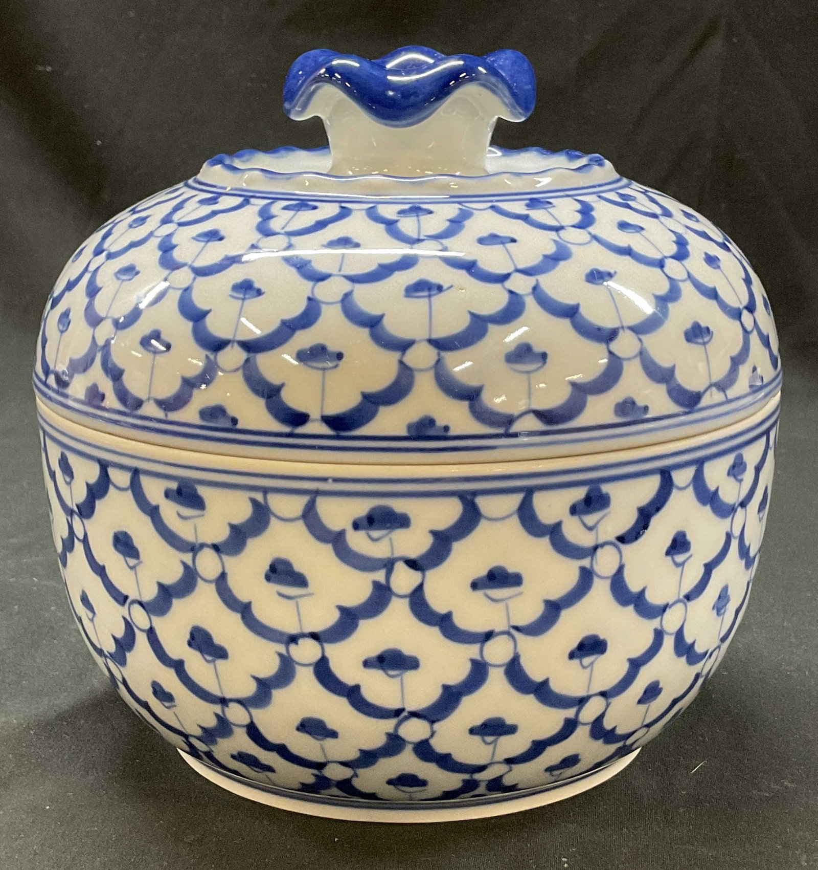 Vintage Thai Style Hand Painted Lidded Ginger Jar: Vintage Thai style hand painted porcelain lidded ginger jar. Domed lid with decorative finial. Scalloped accents. Hand painted blue and white pineapple pattern. Measures ht approx 6 inches diam
