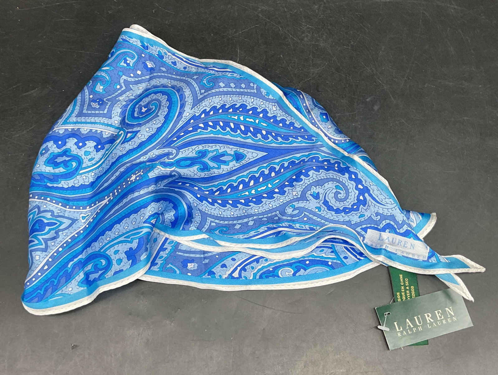 Ralph Lauren Blue Paisley Silk Scarf NWT: Ralph Lauren blue paisley pattern silk scarf. New with tag. Measures approx. 60 inches long. Ralph Lauren scarf, silk scarf, paisley scarf, blue scarf, accessories, wearables, 10 sb