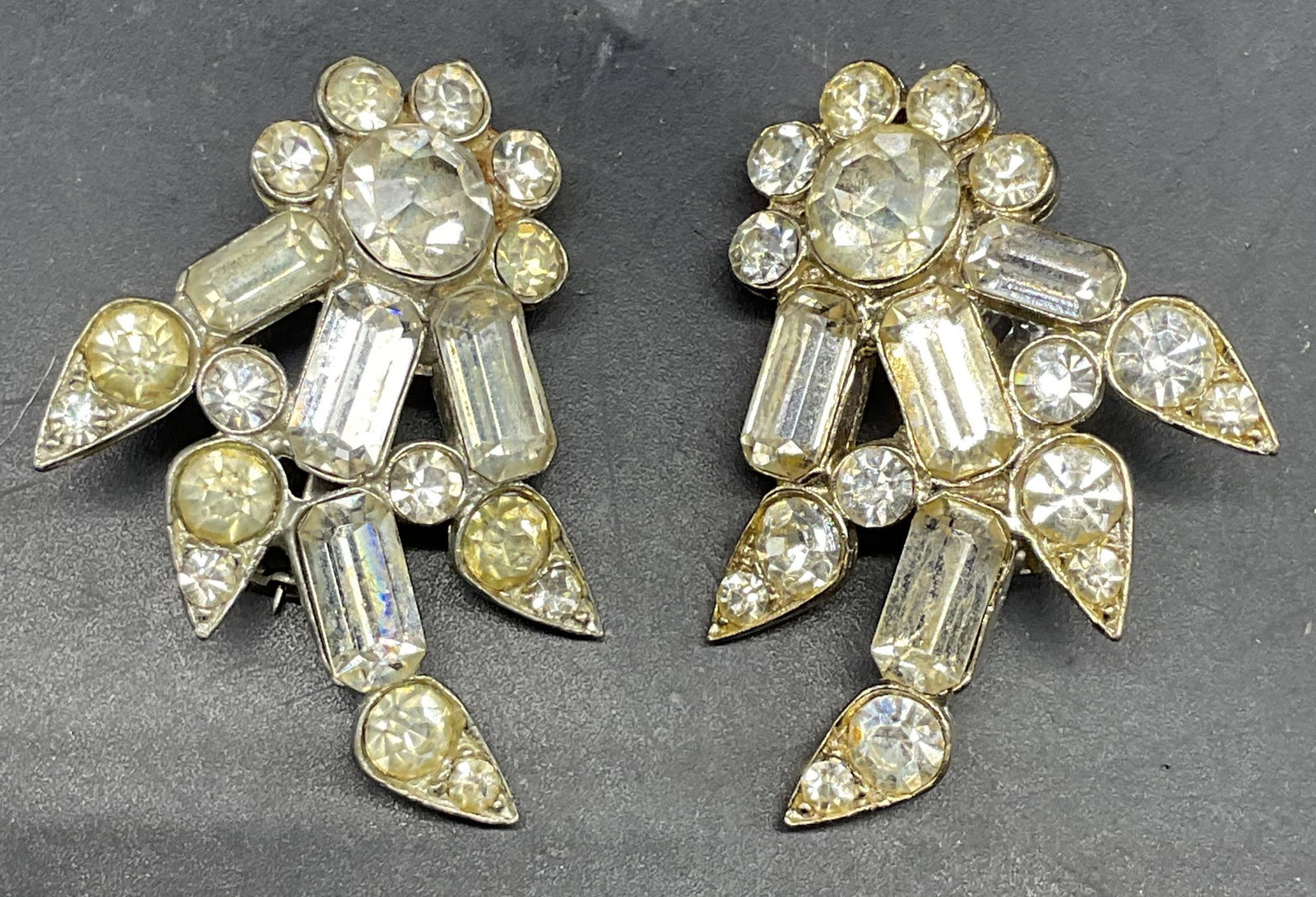 Pair Vintage Silver Tone Crystal Flower Brooches: Pair of vintage silver tone crystal flower brooches. Measures approx. 1.75 x 1.25 inches. Some scratching. Jewelry, estate jewelry, costume jewelry, cocktail jewelry, fashion jewelry, accessories,