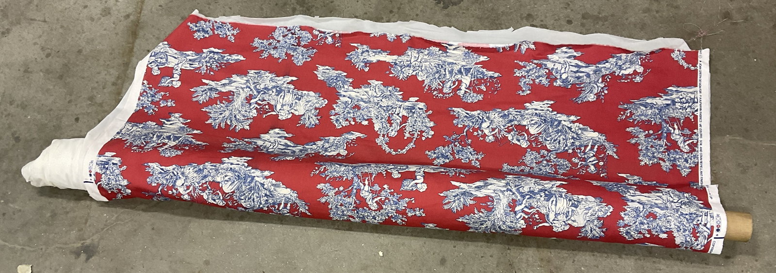 Joan Green for P/Kaufman Toile de Jouy Fabric Bolt: Joan Green Design for P/Kaufman Toile de Jouy Fabric Bolt. Linen Material. Red with Blue and White Classical French Putti and Scenery Designs. Reads Vat Colors Soil and Stain Repellant Finish Printed