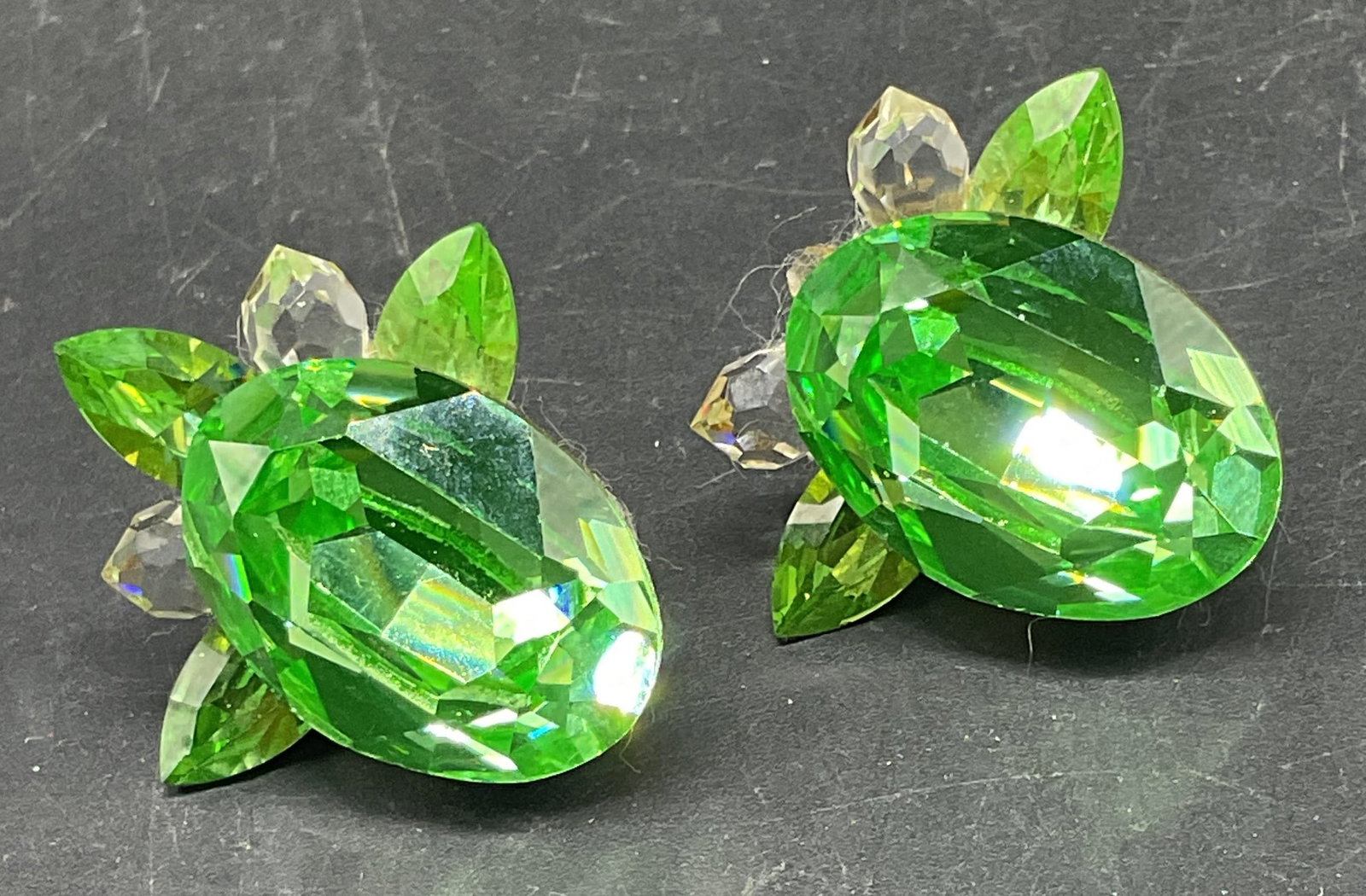 Vintage Green Crystal Earrings: Vintage green and colorless crystal earrings. Measures approx. 1.25 x 1.25 inches. One crystal needs replacement. Some scratching. Jewelry, estate jewelry, costume jewelry, cocktail jewelry, fashion