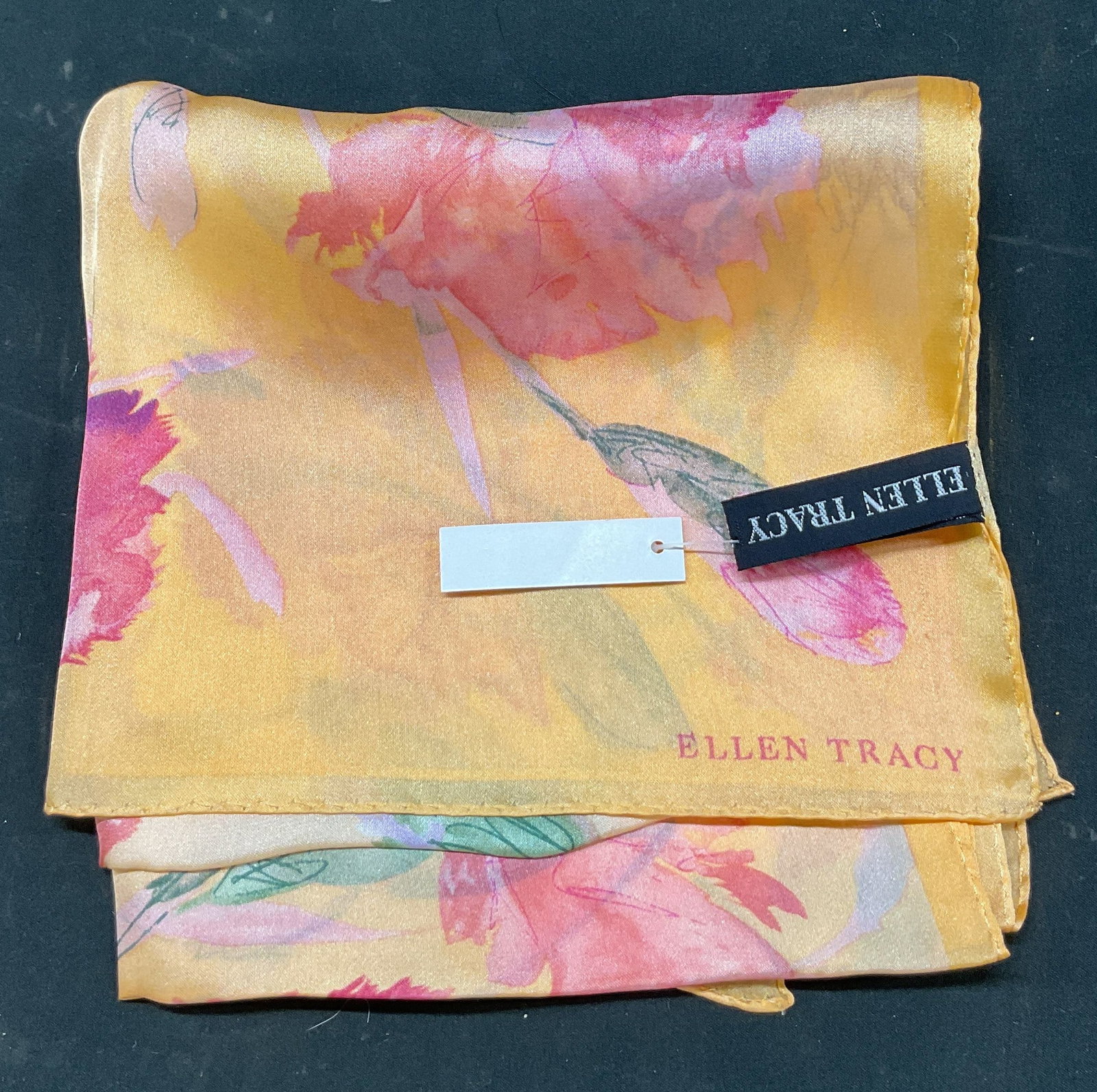 Ellen Tracy Floral Silk Scarf NWT: New with tag. Ellen Tracy floral silk scarf. Orange background. Green, pink, and purple floral motifs. Measures approx 15 x 56 inches. Silk scarf, scarf, Ellen Tracy, wearables, clothing, outerwear,