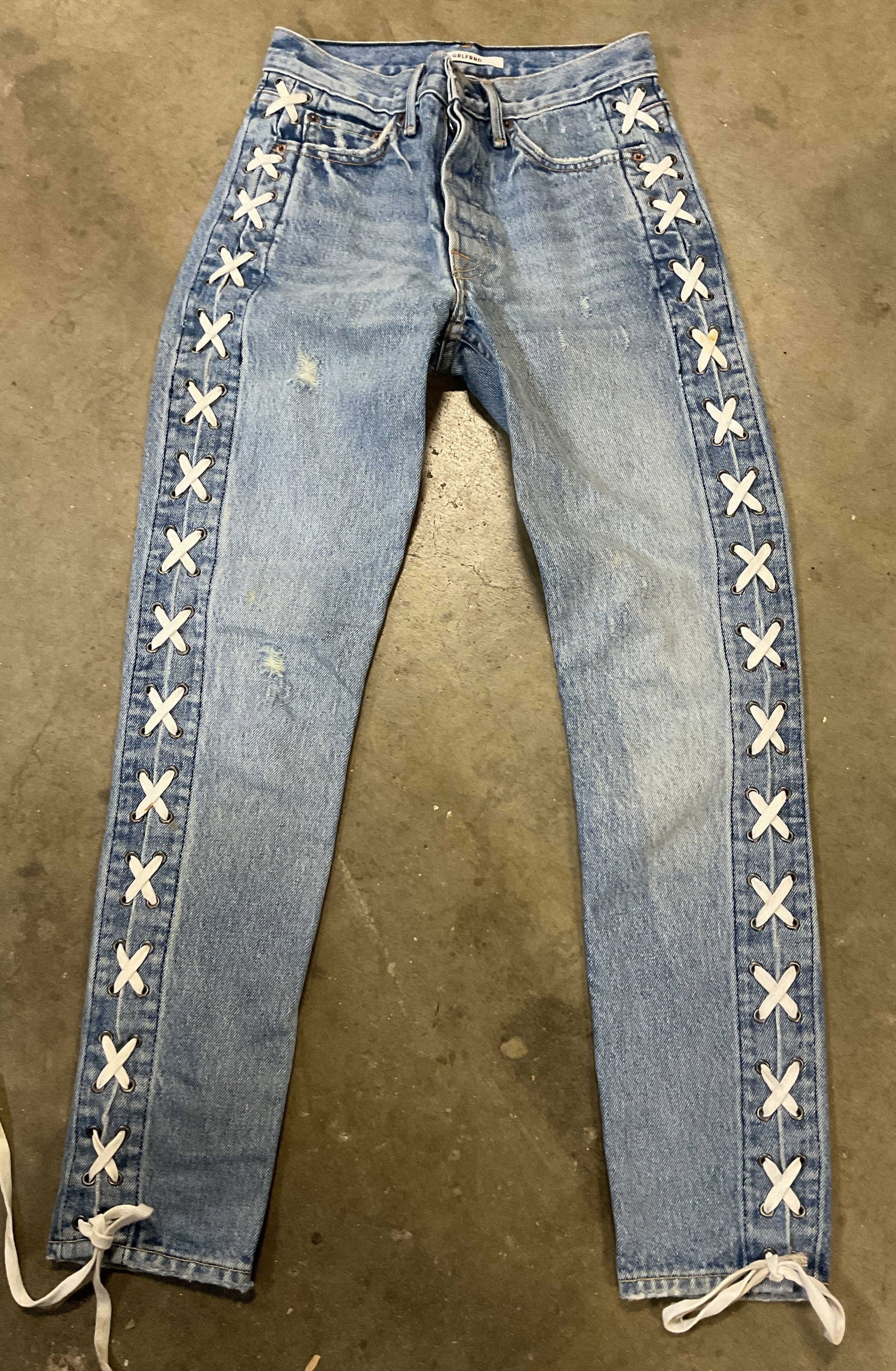 Grlfrnd Light Wash Lace Denim Jeans USA: Grlfrnd light wash lace denim jeans. Made in USA. 100% cotton. Size 23. Shoe lace accent on either side. Wear consistent with exposure, blemishes. Jeans, bottom, pants, Grlfrnd, wearables, clothing, o