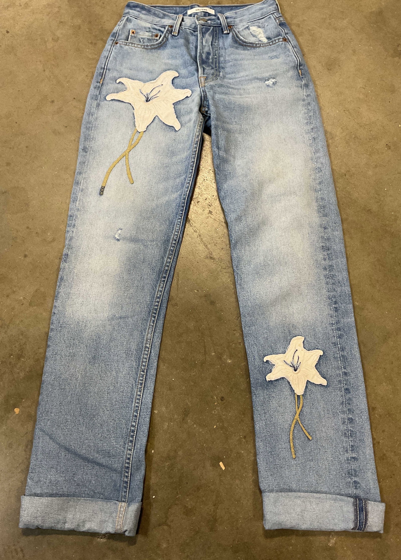 Grlfrnd Embroidered Floral Denim Jeans USA: Grlfrnd embroidered floral light wash denim jeans. Made in USA. 100% cotton. Size 23. Embroidered floral motif in white, green, and blue. Wear consistent with exposure, blemishes. Jeans, bottoms, pant