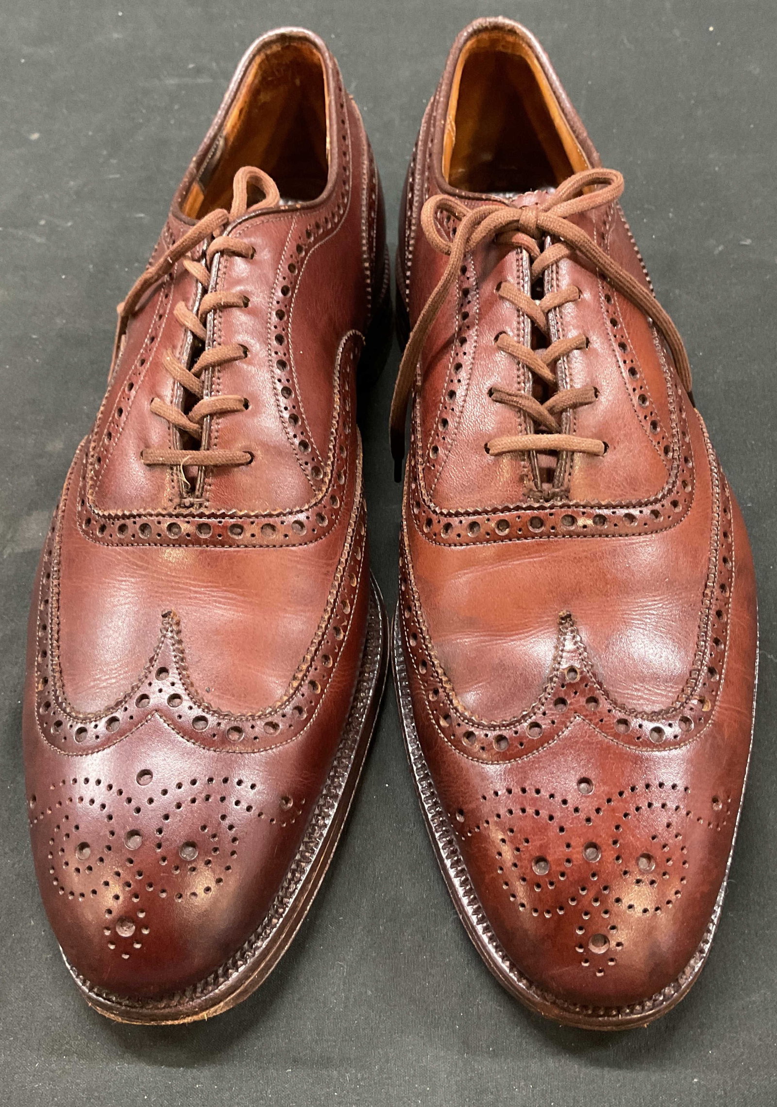 Churchs Brown Leather Loafers England: Churchs brown leather loafers. Made in England. Heeled shoe. Intricate design. Laces. Measures approx 13 inches in length. Wear consistent with exposure. Loafers, shoes, wearables, outerwear, fashion,