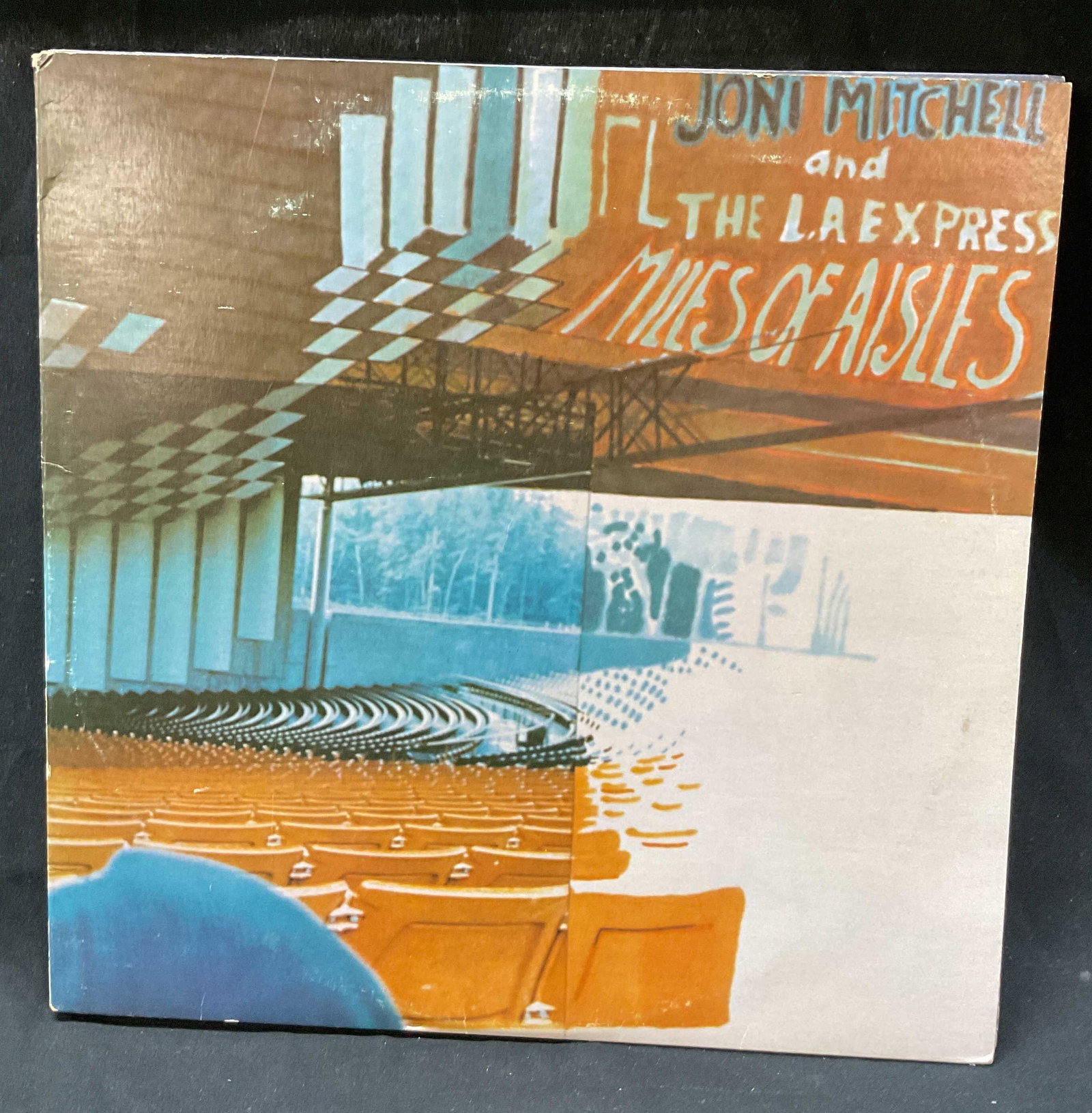 1974 Joni Mitchell+ Miles Of Aisles Vinyl Record: Miles Of Aisles by Joni Mitchell and The LA Express. Manufactured by Asylum Records. Copyright 1974 Crazy Crow Music. Illustrations and text as photographed here. Includes two vinyl. Measures approx 1