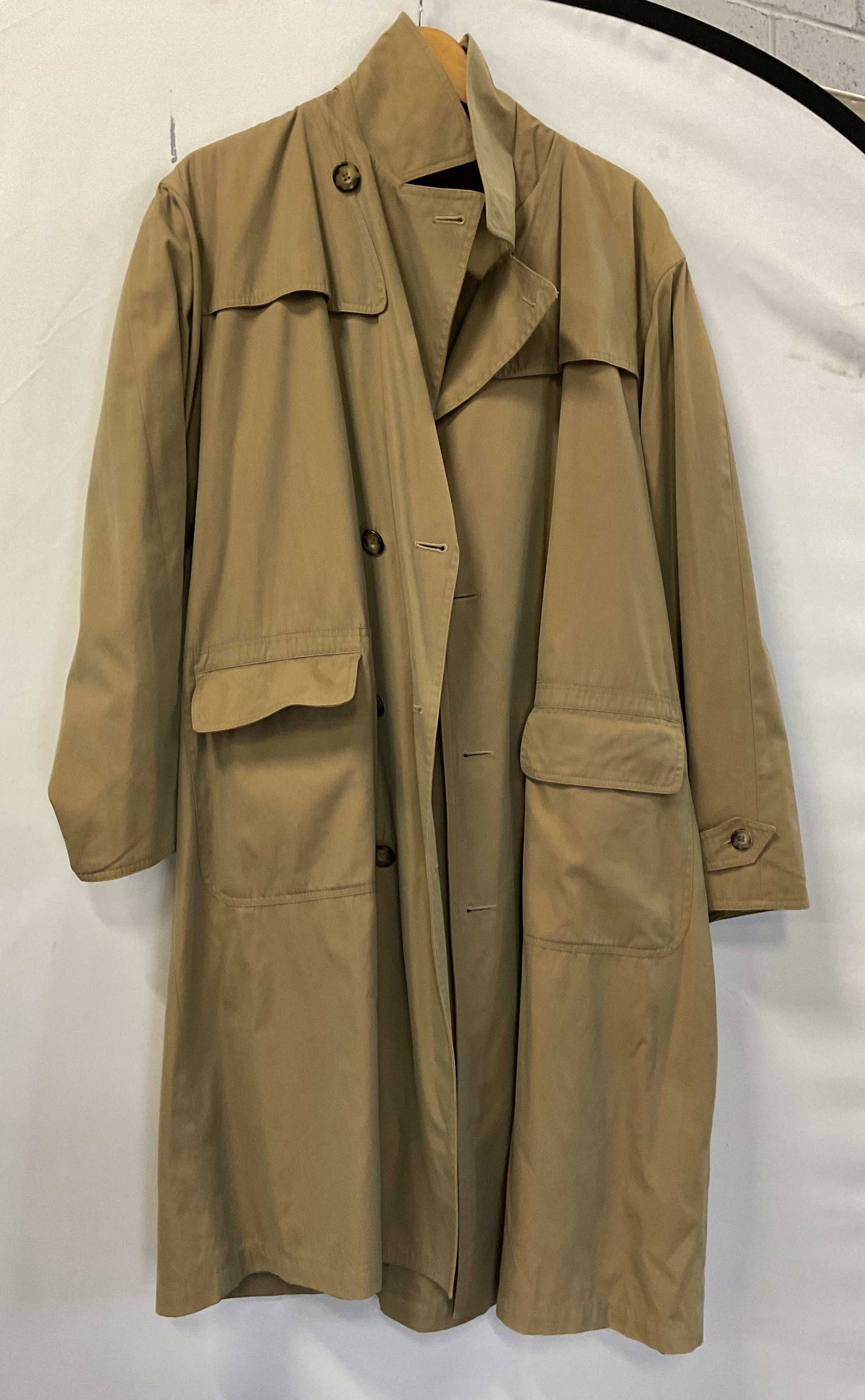 Vintage Beige Trench Coat Italy: Vintage beige trench coat. Made in Italy. 80% cotton. Collared and buttoned accents. Pockets. Measures approx 21 inches across chest. Wear consistent with exposure. Trench coat, coat, wearables, cloth