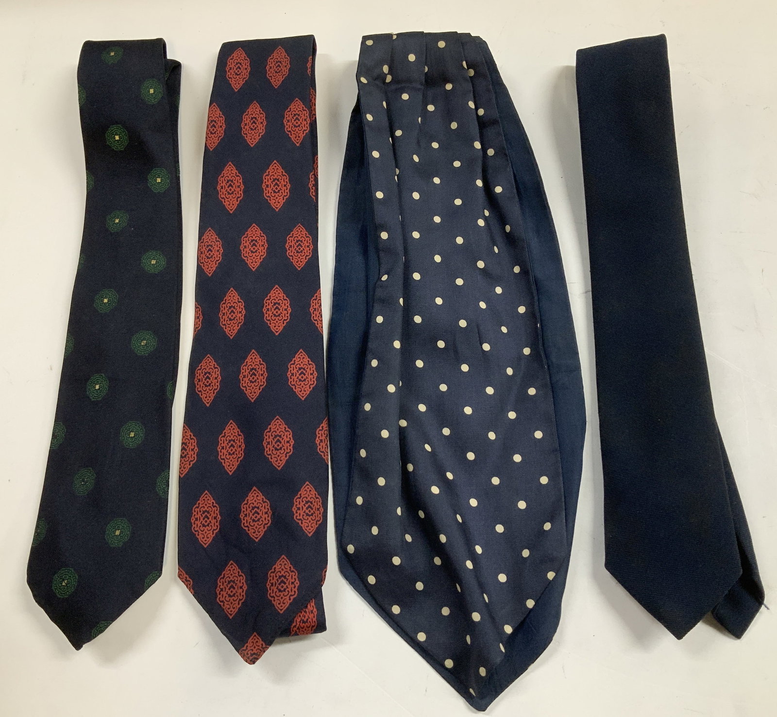 Lot 4 Vtg Assorted Neckties CHRISTIAN DIOR+: Lot includes, 1 navy necktie, 1 polka dot necktie, 1 Salvatore Morziello necktie with a red geometric pattern & 1 Christian Dior silk necktie with a green geometric pattern. Assorted sizes. Sold as