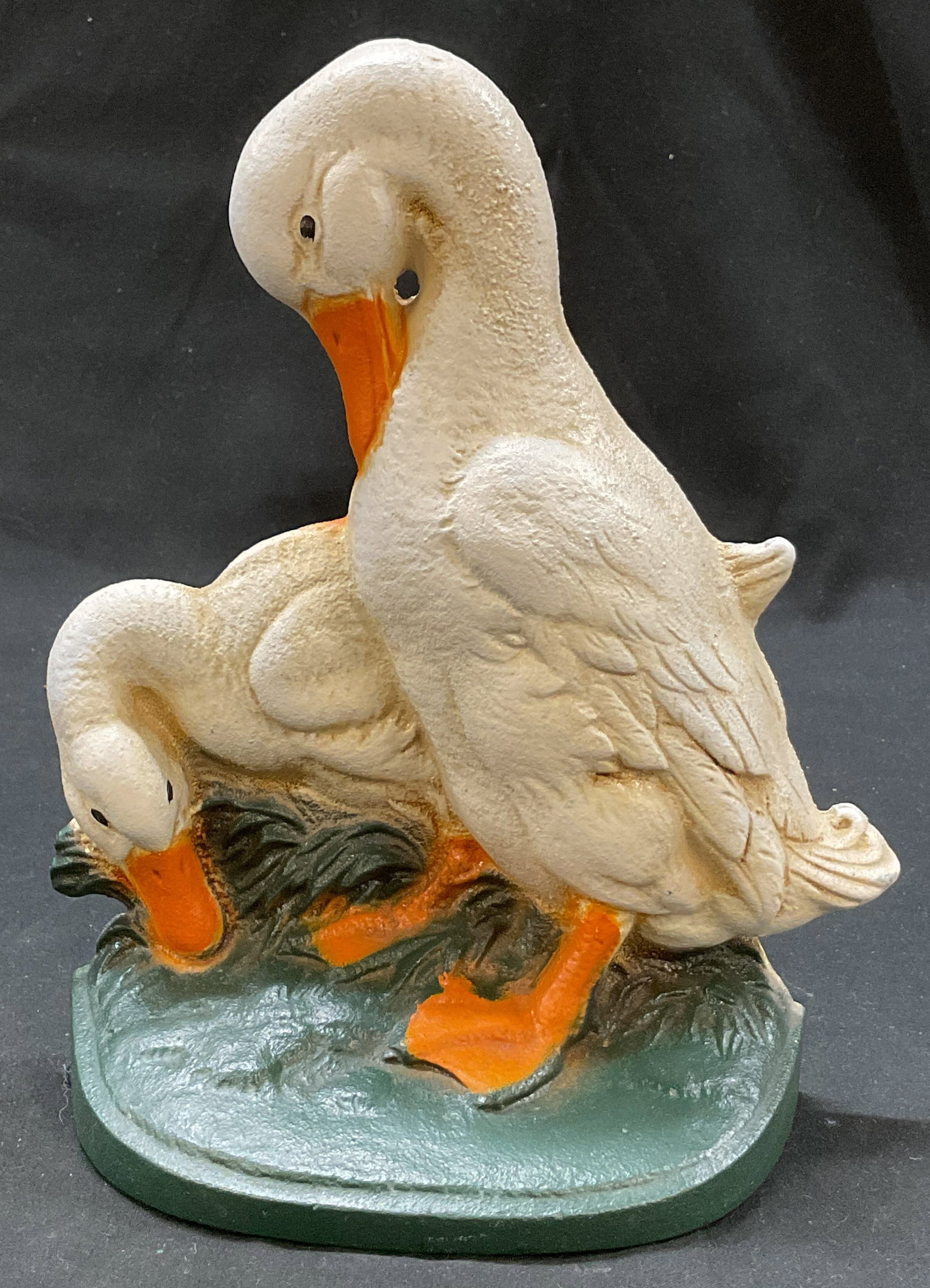 John Wright Cast Iron Duck Doorstop USA: John Wright cast iron duck doorstop. Marked on backside, reads J.W. Cast In USA. Two duck figures on a grassy patch. Hand painted white, orange, and green. Measures approx 2.5 x 5.5 x 8 inches. Scratc