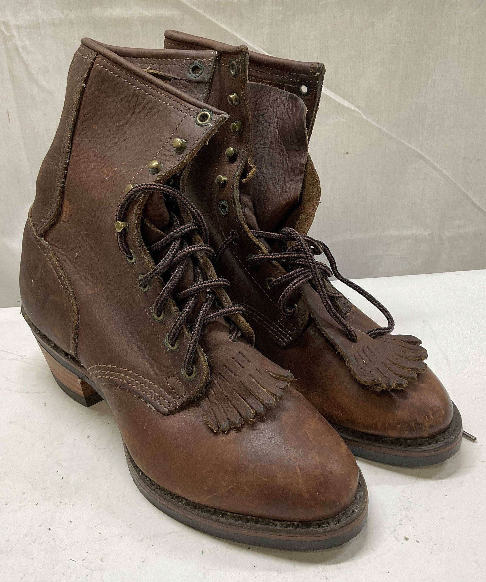 PD Tuff Western Leather Lace-Up Boots: PD Tuff Western Leather Lace-Up Boots. Kiltie Tassles. Vibram Soles. Surface Wear to Leather and Metal Present. Measures app 9.5in H x 3.5in W. Comes With Box. PD Tuff, Western Boots, Leather, Lace-Up