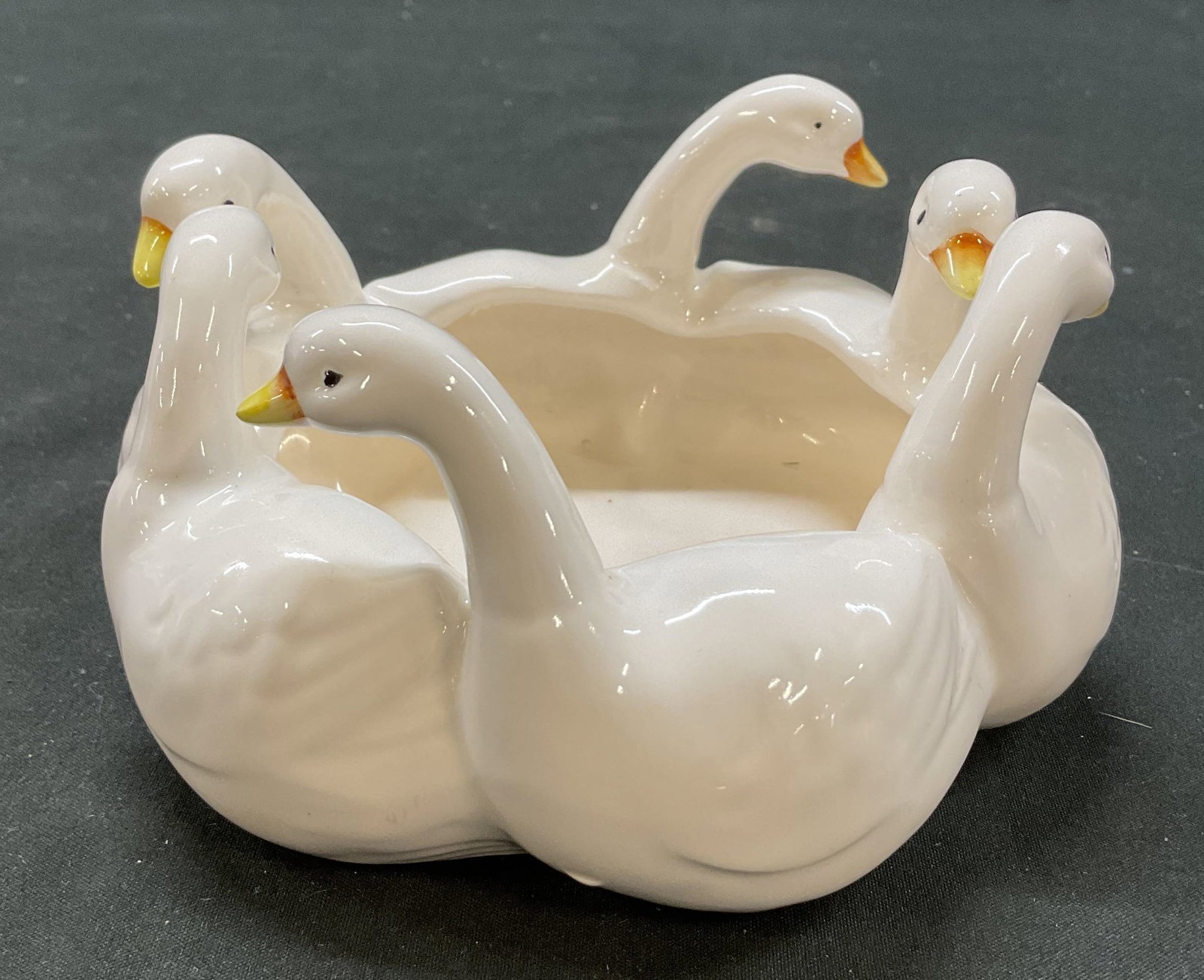 Ron Gordon Designs Ceramic Geese Bowl: Ron Gordon Designs ceramic geese bowl. Circular bowl with geese figures all around. White, black, orange, yellow. Measures approx 5 inches in diameter. Surface wear consistent with exposure. Bowl, Ron