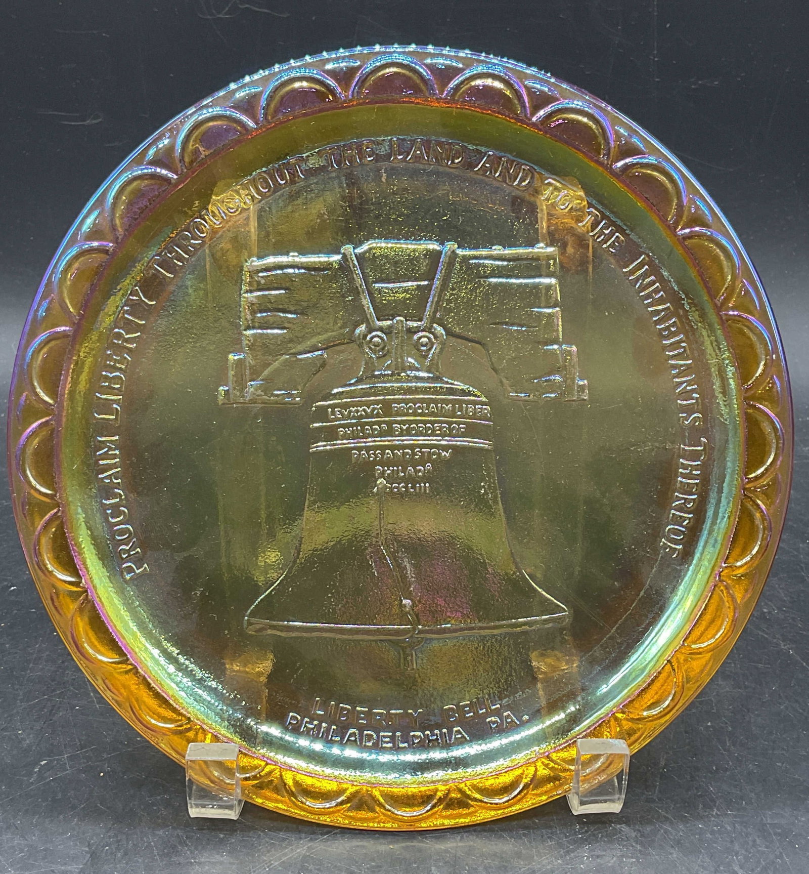 Indiana Glass Liberty Bell Carnival Glass Plate: Vintage Indiana Glass Bicentennial Liberty Bell Commemorative carnival glass plate. Measures approx. 8 inches wide. Unsigned. Some scratching. Indiana glass plate, liberty bell plate, bicentennial pla