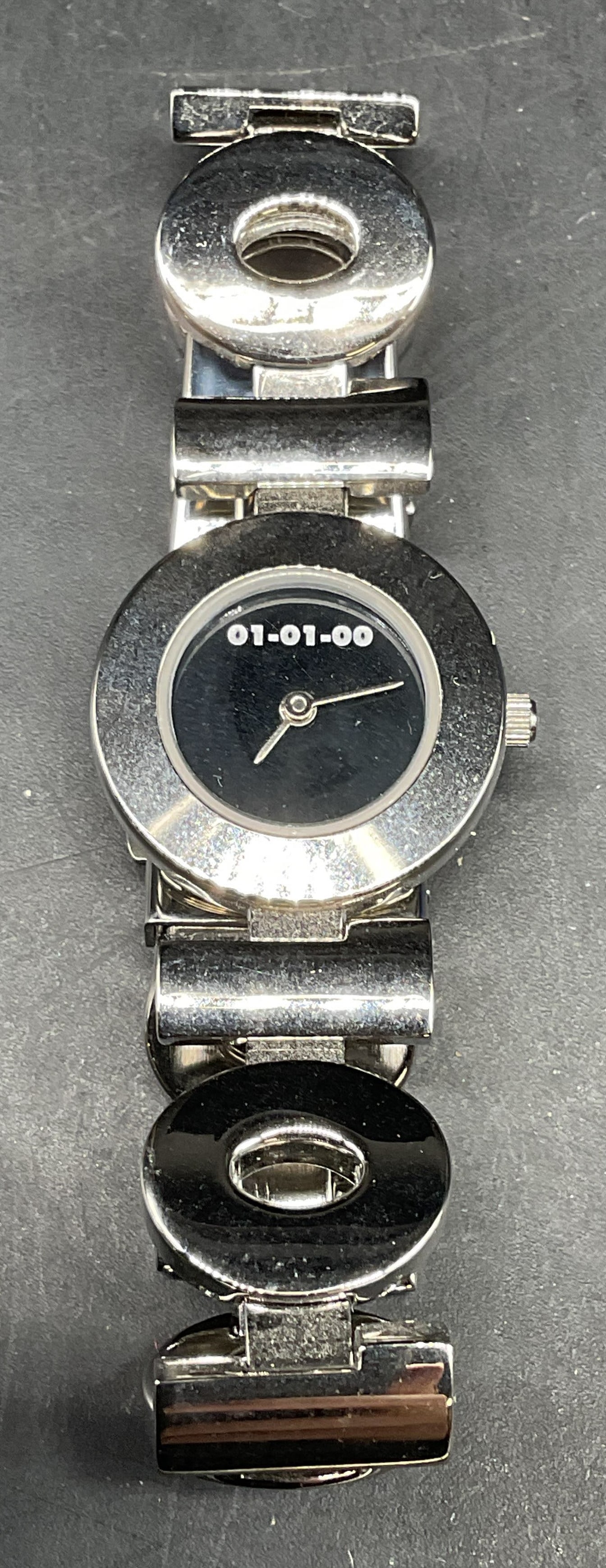 01 01 00 Millennium Limited Edition Watch: 01 01 00 The Mark Of The Millenium silver tone watch. Limited edition, unnumbered. Deployment clasp. Face measures approx. 1 inch wide. Not tested. Some scratching. Jewelry, estate jewelry, costume
