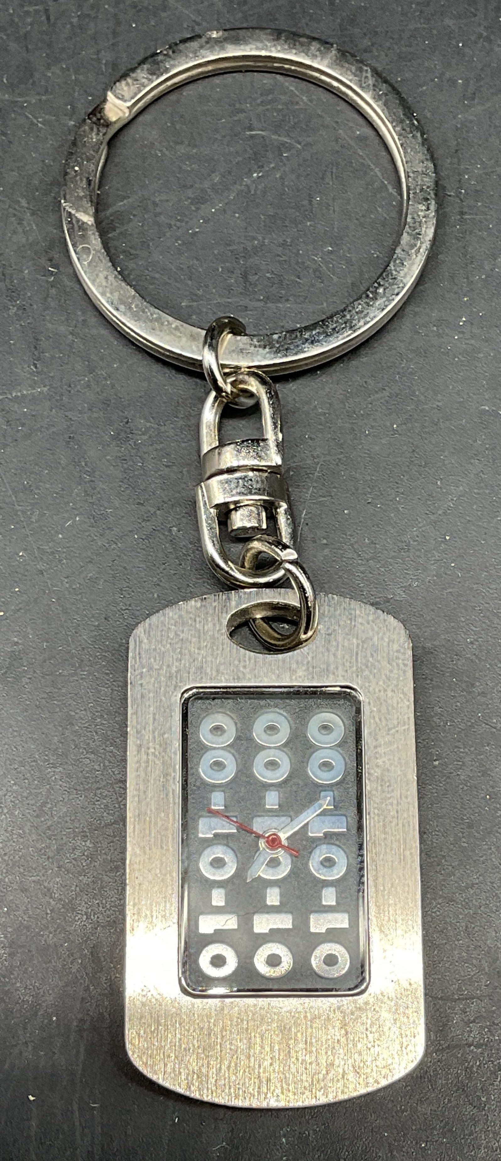 01 01 00 Millennium Keychain Watch NWOT: 01 01 00 The Mark Of The Millenium silver tone keychain watch. New without tag. Watch pendant measures approx. 1.25 x 1 inches. Not tested. Some scratching. Jewelry, estate jewelry, costume jewelry,