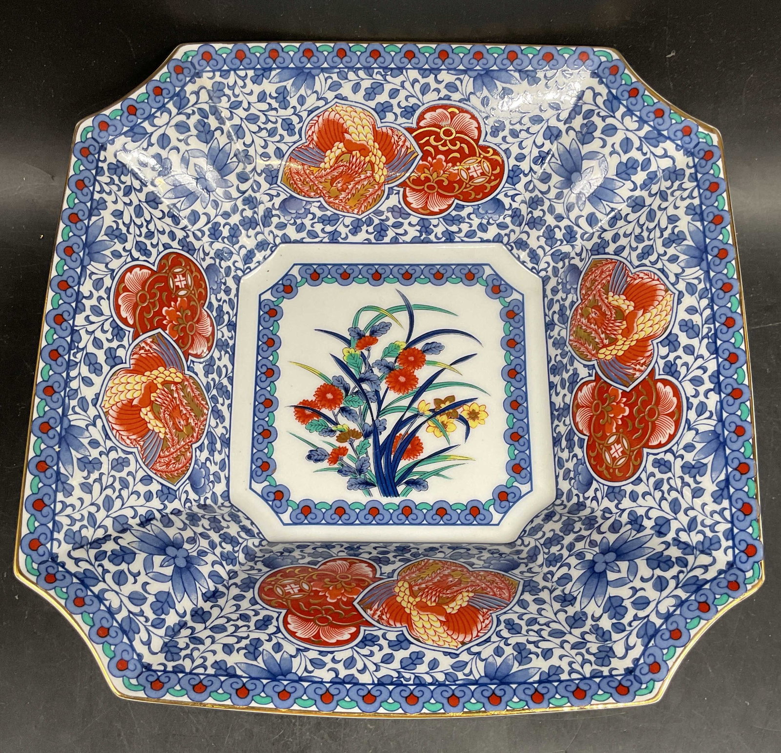 Signed Japanese Imari Style Floral Porcelain Bowl: Signed Japanese Imari style porcelain bowl with floral and bird motifs in blue and red. Measures approx. 10 x 10 x 3 inches. Some scratching. Imari style bowl, porcelain bowl, floral bowl, bird bowl, 