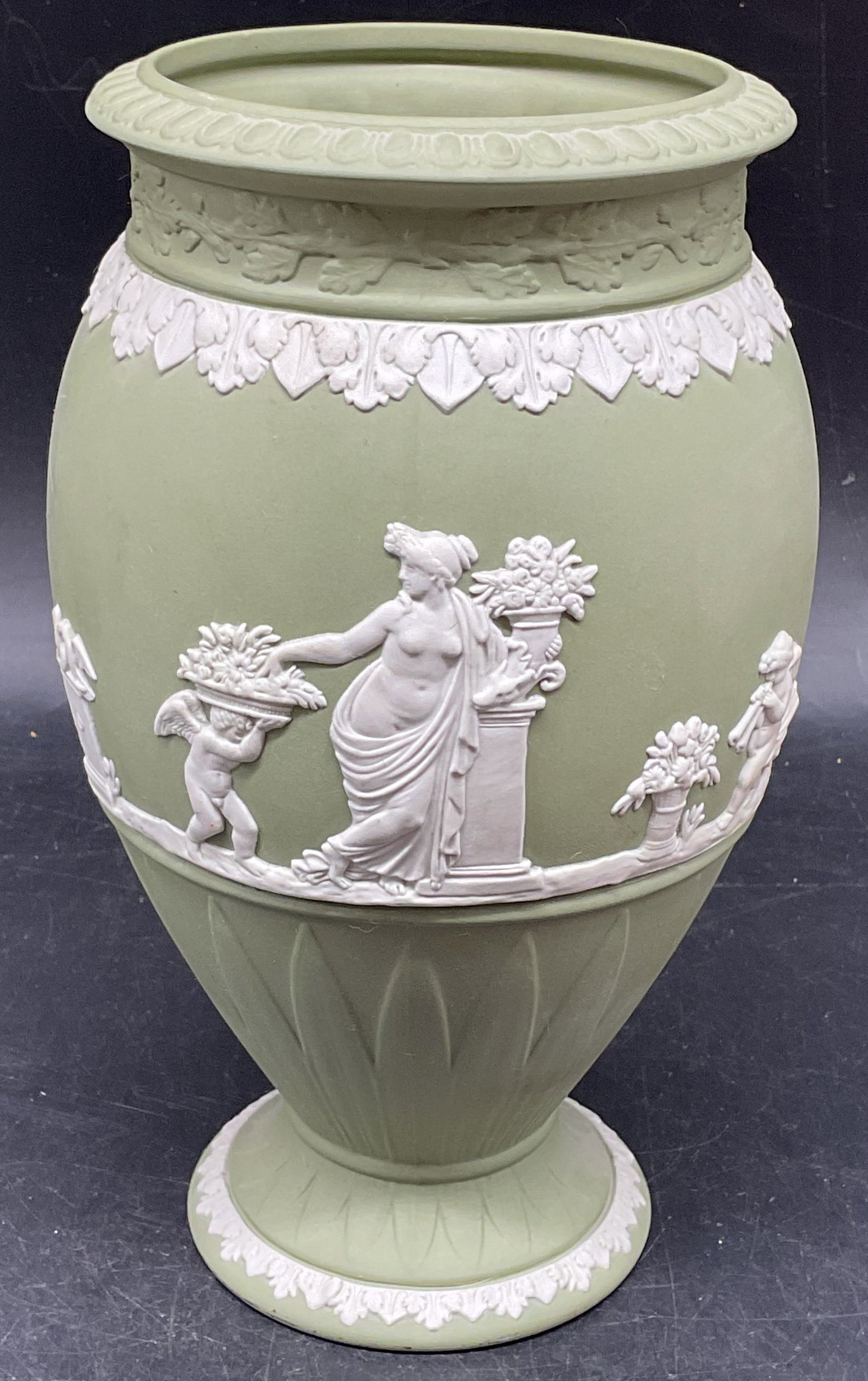 Wedgwood Green Jasperware Vase, England: Wedgwood sage green Jasperware vase with white classical figural relief. Made in England. Measures approx. 4.75 x 8 inches. Some scratching. Wedgwood vase, Jasperware vase, collectibles, home decor, t