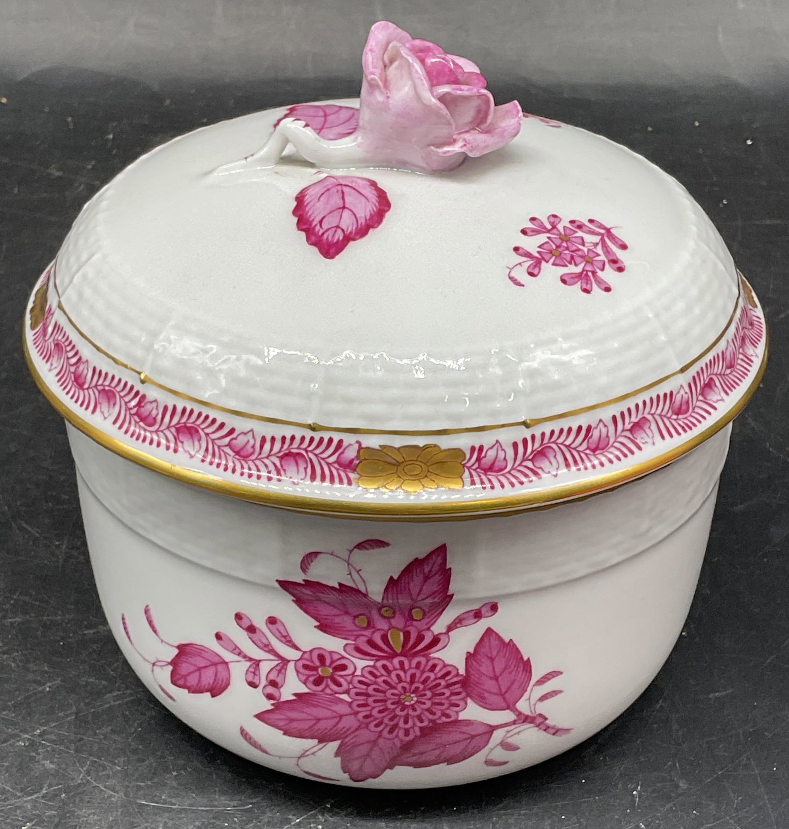 Herend Chinese Bouquet Lidded Porcelain Bowl: Herend Chinese Bouquet pattern porcelain lidded bowl in raspberry. Raised flower lid. Hand painted. Made in Hungary. Measures approx. 4.5 x 4.75 inches. Small chip on flower, some scratching. Herend b