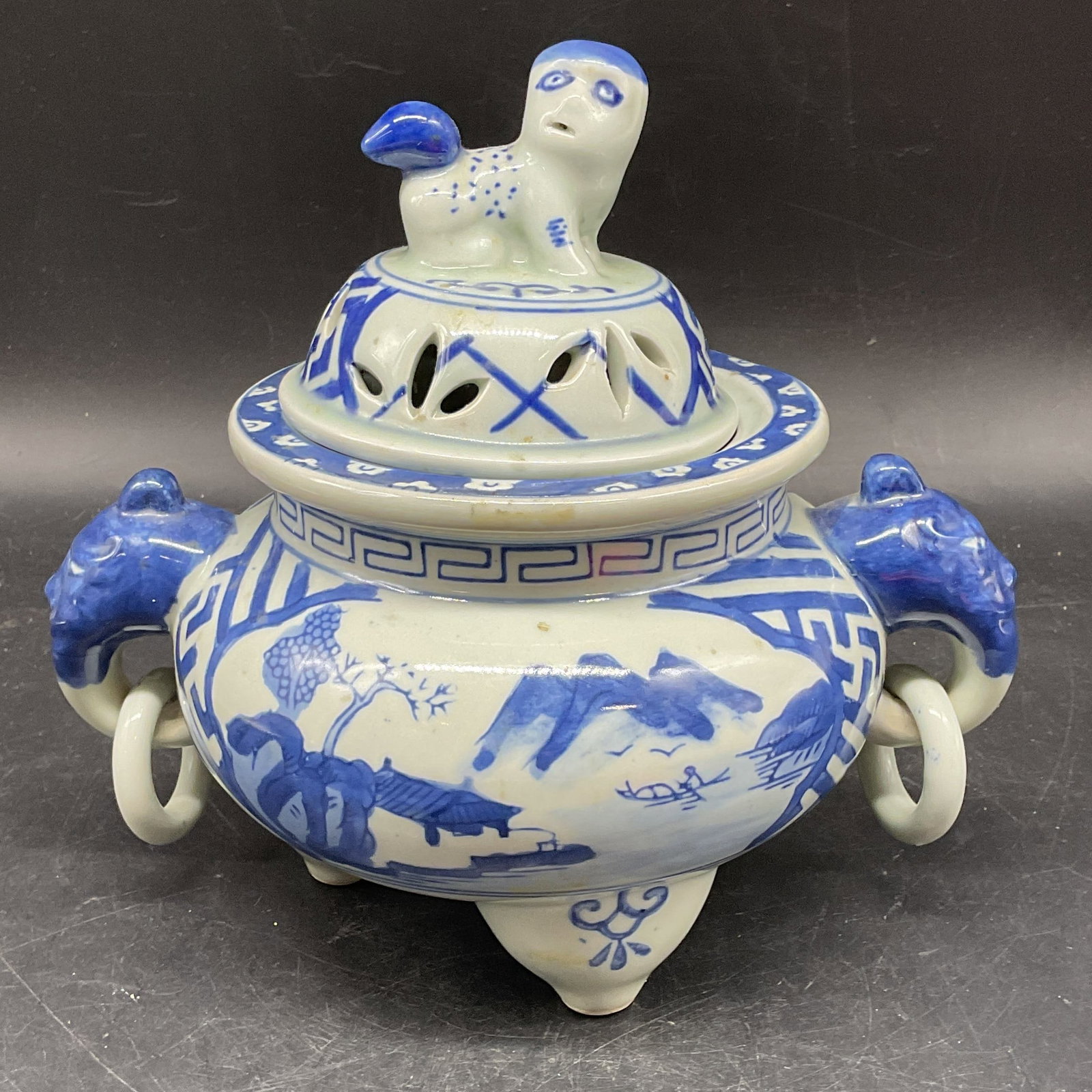 Chinese Blue & White Porcelain Incense Burner: Chinese blue and white hand painted porcelain incense burner with foo dog and dragon finials. Landscape scene. Measures approx. 9 x 5.75 x 7.5 inches. Some scratching. Chinese incense burner, blue and