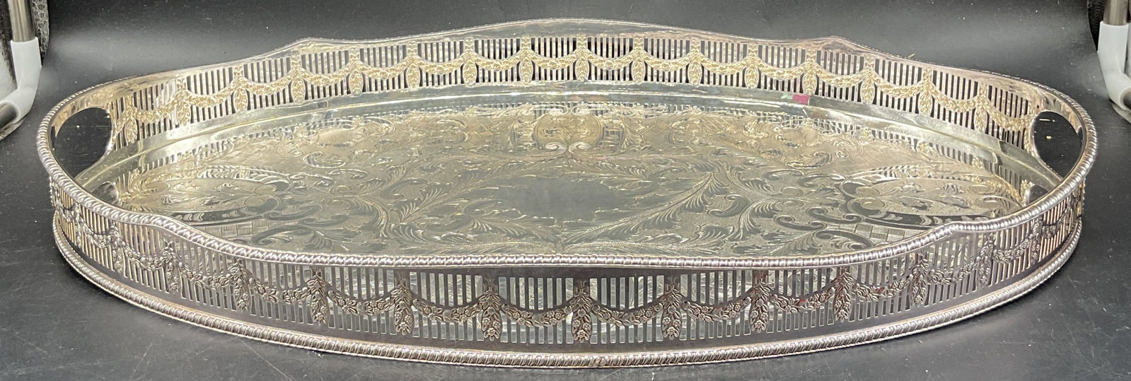 Viners Sheffield Silver Plated Ornate Chased Tray: Vintage Viners of Sheffield silver plated oval tray. Ornate chased scroll design with reticulated rim. Made in England. Measures approx. 18 x 12 x 1.75 inches. Some patina and scratching. Viners tray,