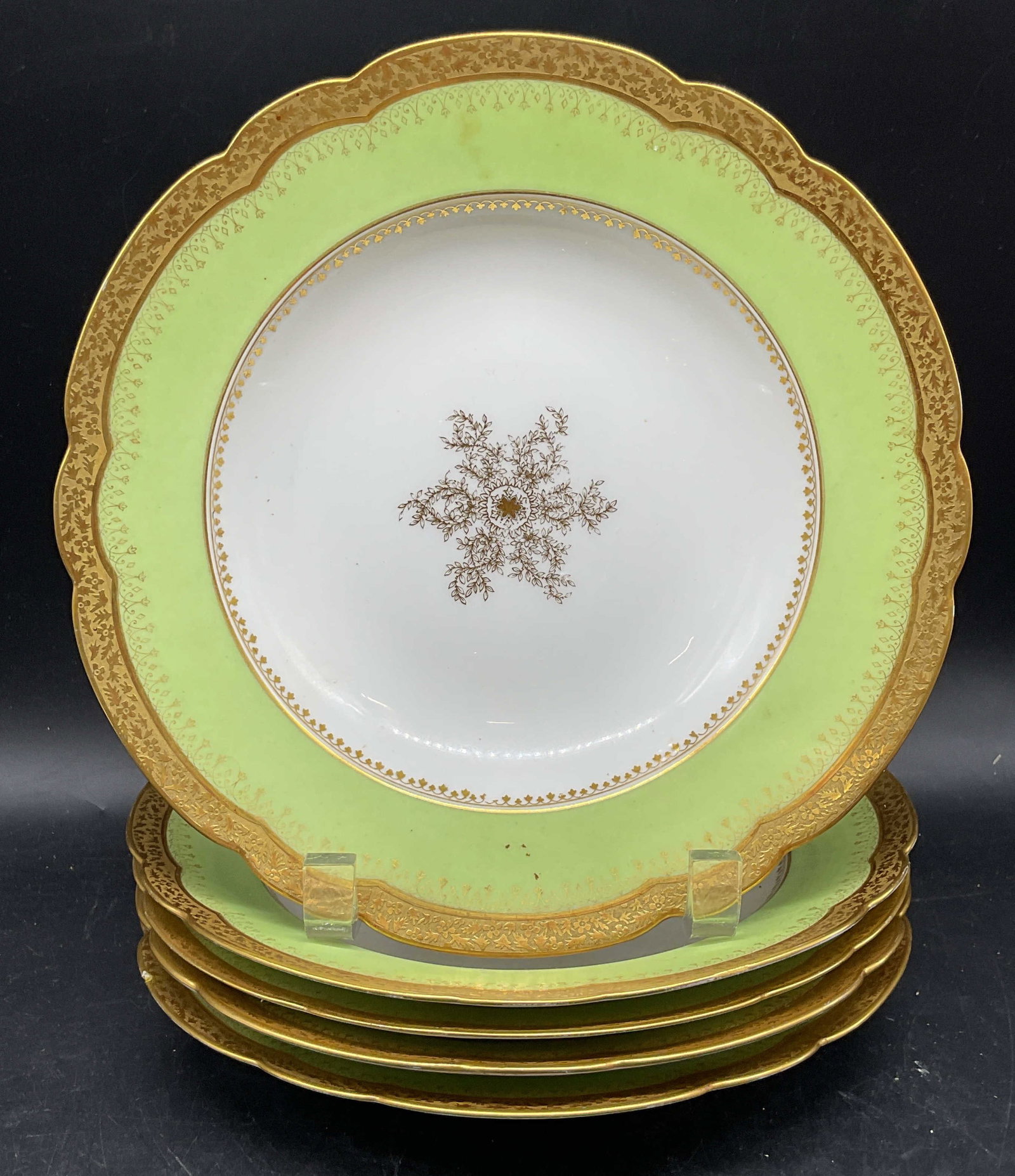 Set 5 Plummer Limoges Green Gilt Porcelain Bowls: Set of 5 antique W. H. Plummer Limoges porcelain bowls. Made in France. Hand painted green and gilt rims with ornate floral centers. Measures approx. 9 x 1.5 inches. Some residue, scratching, and loss