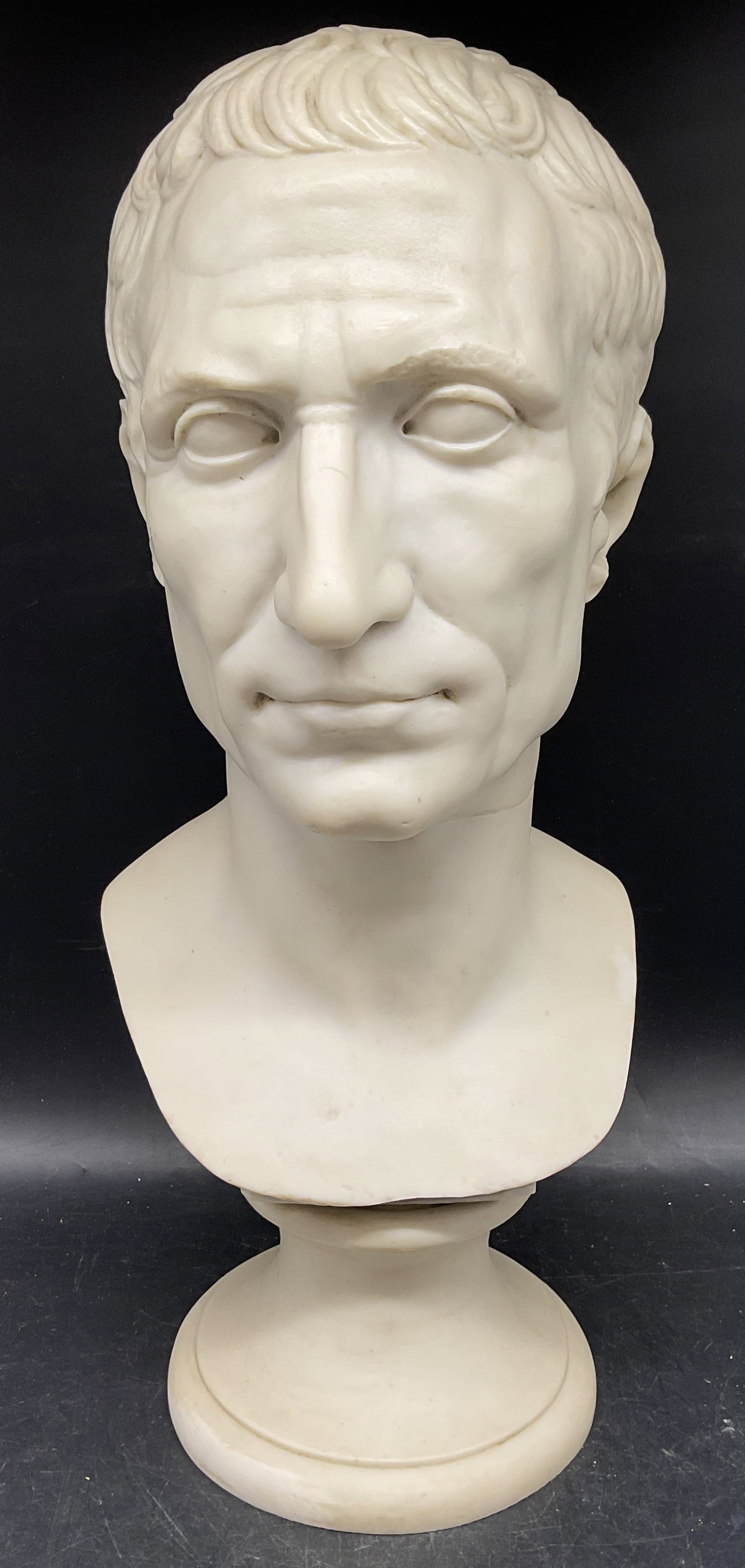 Edizioni Musei Vaticano Bust of Julius Caesar: Edizioni Musei Vaticano bust of Julius Caesar. Made in Italy. Hard composite material, bust has significant weight. Measures approx. 7.5 x 8 x 18.5 inches. Some scratching and marks. Julius Caesar bus