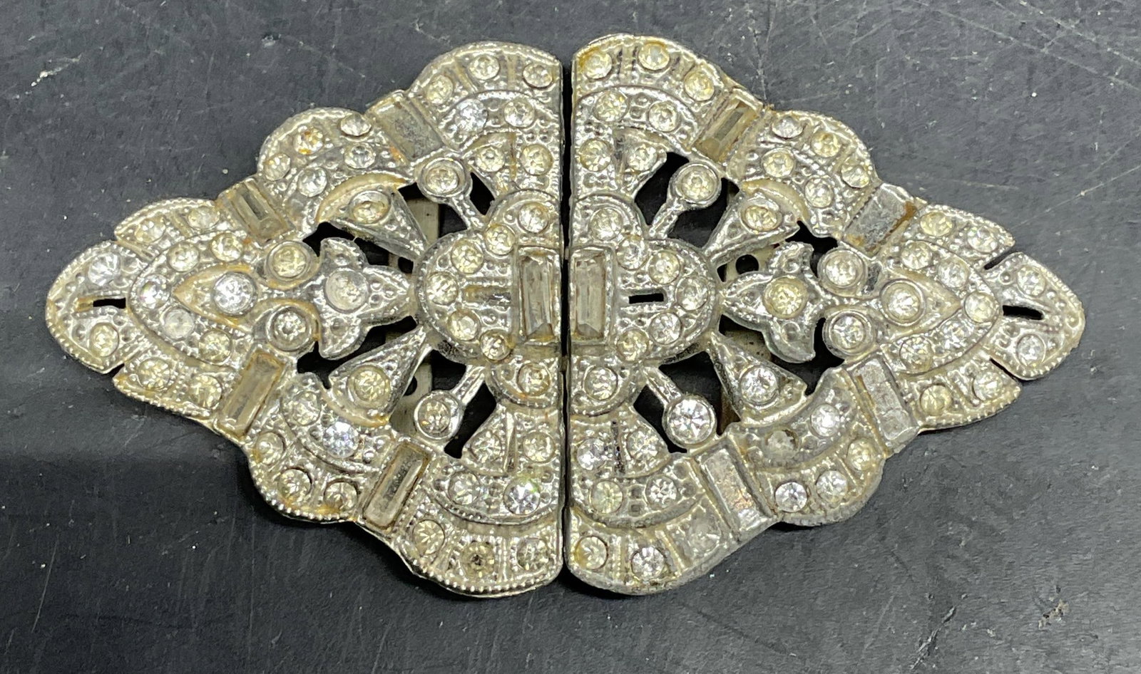 Art Deco WMCA Rhinestone Belt Buckle: Art deco WMCA White Metal Casters Association two piece rhinestone belt buckle. Measures approx. 3 x 1.75 inches. Some scratching. Some rhinestones need replacement. WMCA belt buckle, art deco belt bu