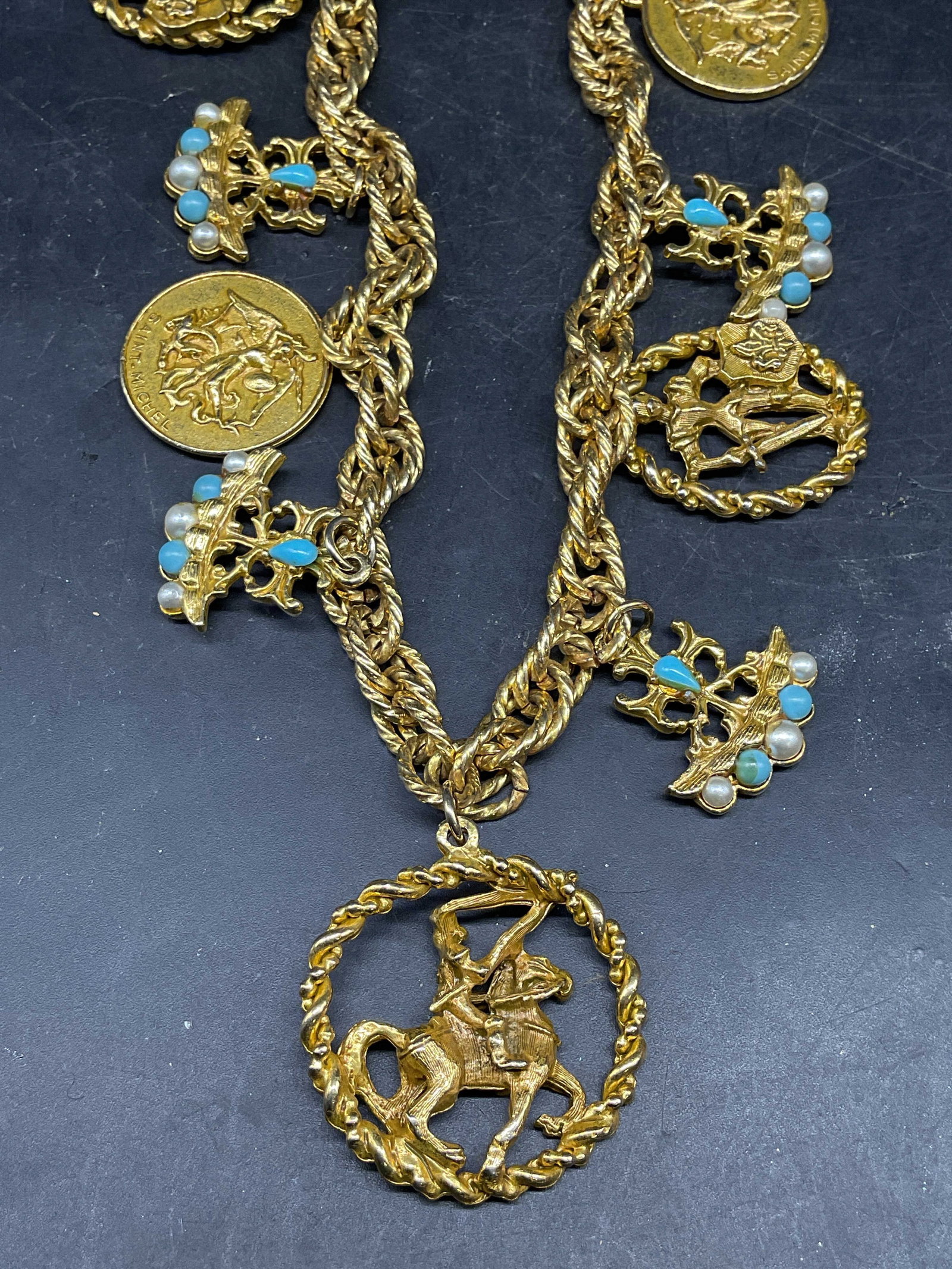 Gold Tone Knight Saint Michael Pendant Necklace: Vintage gold tone necklace with knight and Saint Michael motif pendants. Drop length 7.5 inches. Some scratching. Jewelry, estate jewelry, costume jewelry, cocktail jewelry, fashion jewelry, accessori