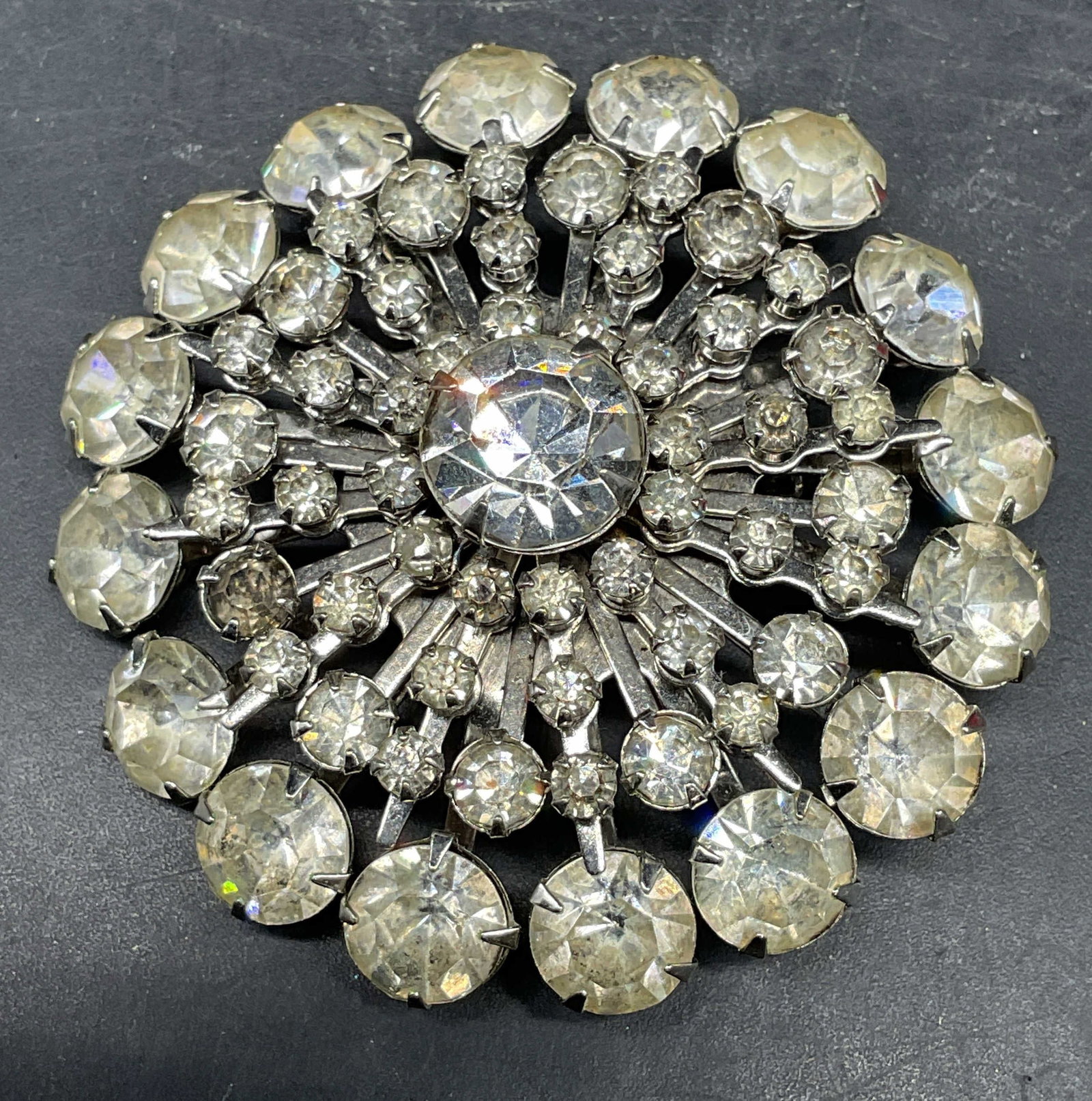 Vintage Silver Tone Rhinestone Flower Brooch: Vintage silver tone rhinestone flower brooch. Measures approx. 2 inches diameter. Some scratching. Jewelry, estate jewelry, costume jewelry, cocktail jewelry, fashion jewelry, accessories, fashion acc