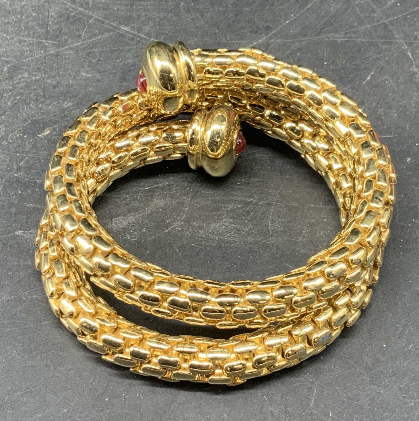 Vintage Gold Tone Chain Wrap Bracelet: Vintage gold tone chain wrap bracelet with red lucite cabochons at terminals. Measures approx. 2.25 inches wide. Some scratching. Jewelry, estate jewelry, costume jewelry, cocktail jewelry, fashion je