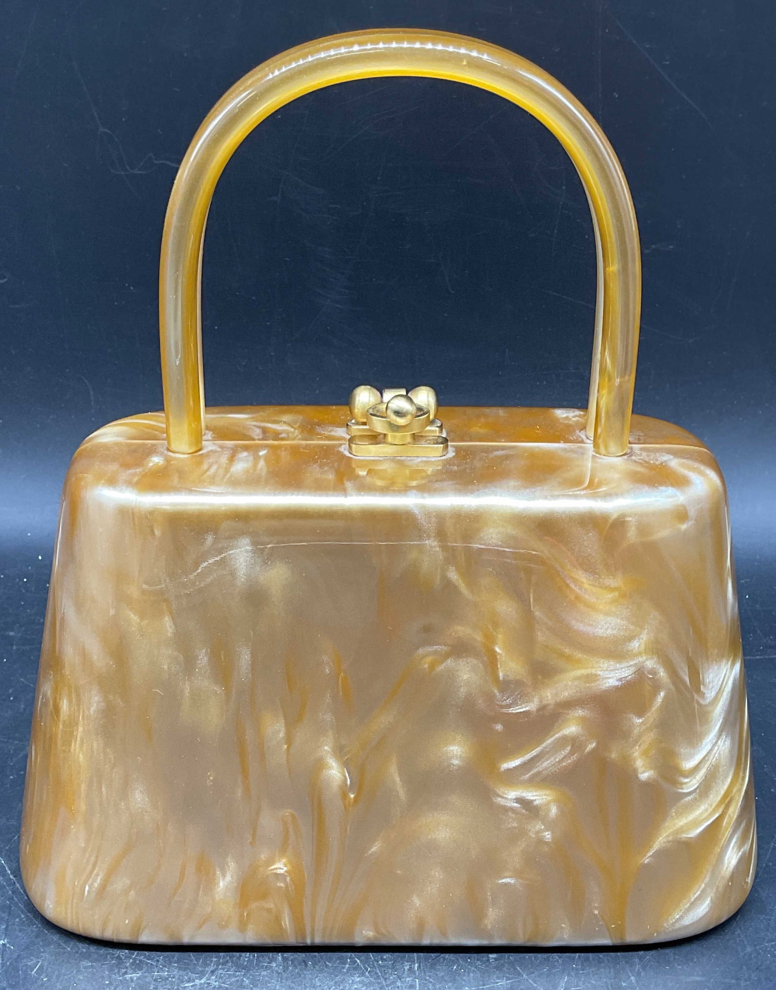 Carlo Fellini Gold Lucite Hard Shell Handbag: Carlo Fellini gold lucite hard shell evening handbag. Labeled Carlo Fellini and Hartley on interior. Measures approx. 8 x 3.75 x 4.75 inches. Some scratching. Carlo Fellini handbag, lucite handbag, go