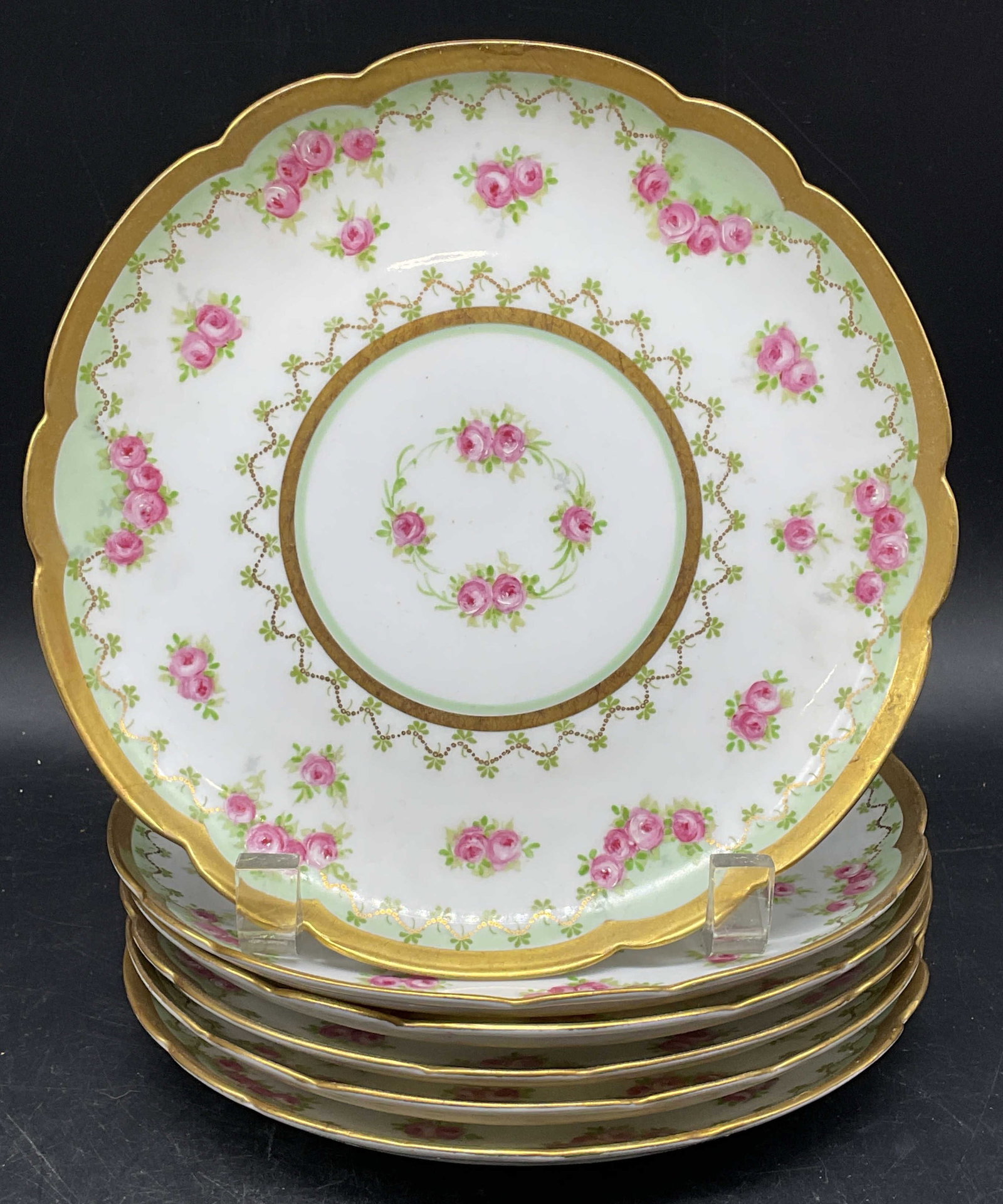 6 Antq BMoeM Coronet Limoges Plates, France: Set of 6 antique BMoeM and Coronet Limoges porcelain plates. Hand painted floral designs in pink and green with gilt decoration. Scalloped rims. Made in France. Measures approx. 7.75 inches wide. Some