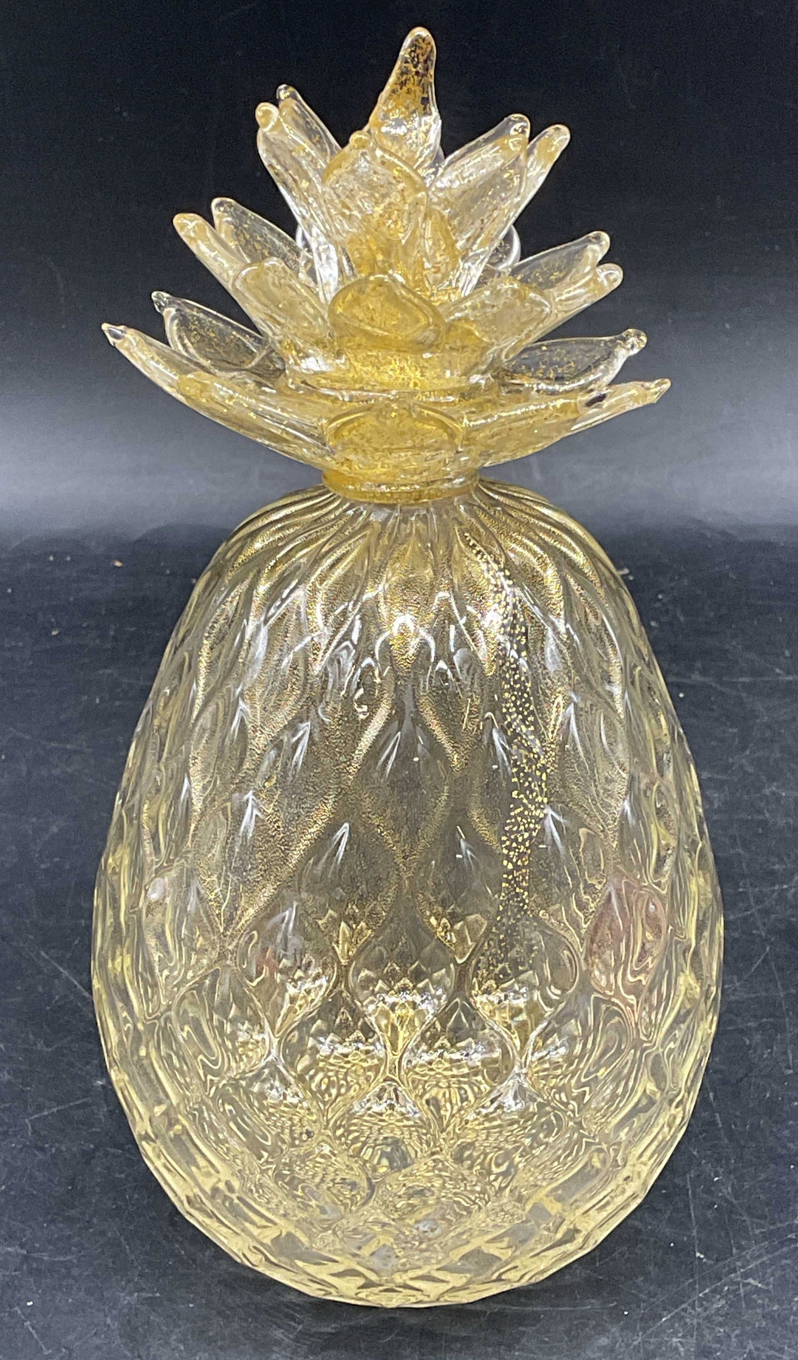 Murano Hand Blown Gold Fleck Art Glass Pineapple: Murano hand blown art glass pineapple. Clear glass with gold fleck. Style of Luigi Fornasier, unsigned. Measures approx. 3.75 x 7.5 inches. Some scratching. Art glass pineapple, pineapple, collectible