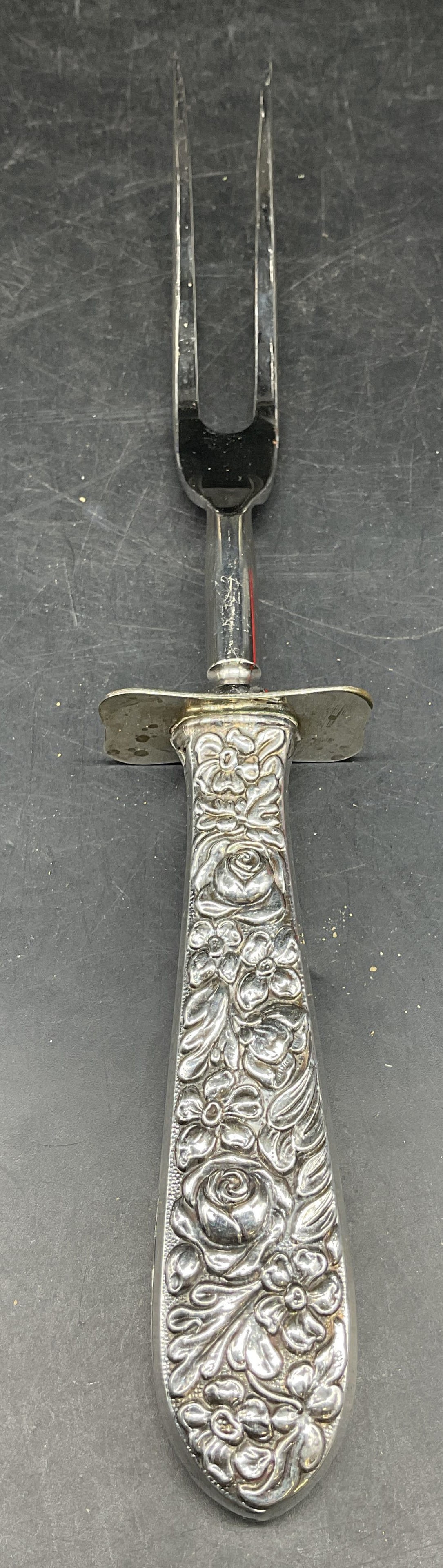 Vintage Sterling Silver Repousse Meat Fork: Vintage sterling silver handle meat fork with repousse floral design. Measures approx. 10.25 inches long. Hole at top of handle, some scratching and patina. Sterling silver fork, meat fork, serving fo
