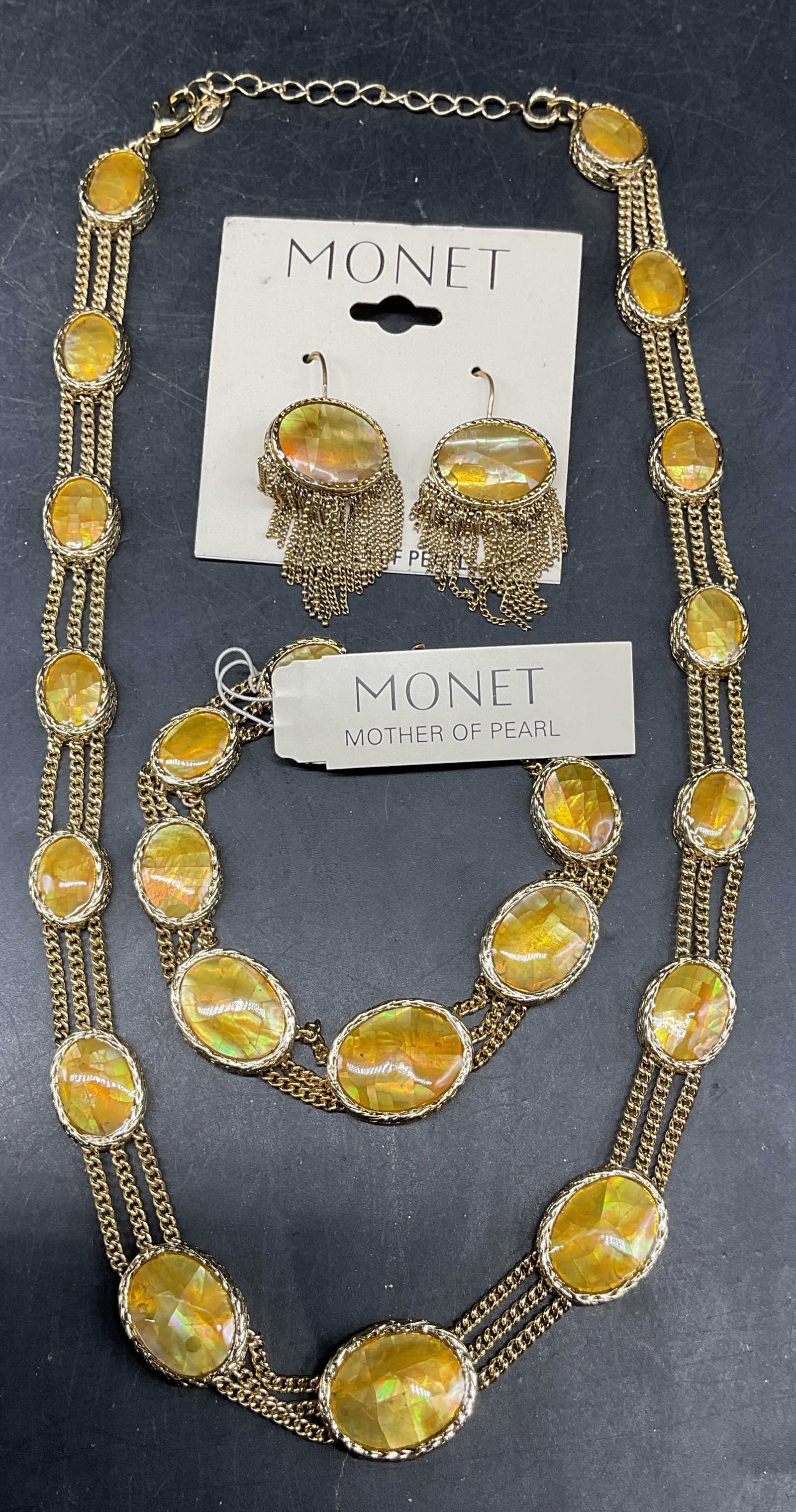 Set 3 Monet Gold Tn Mother of Pearl Jewelry: Set of 3 pieces matching Monet gold tone and mother of pearl jewelry. 1 pair of earrings, new with tag, 1 bracelet, new with tag, and 1 necklace. Necklace drop length 8 inches. Bracelet measures appro
