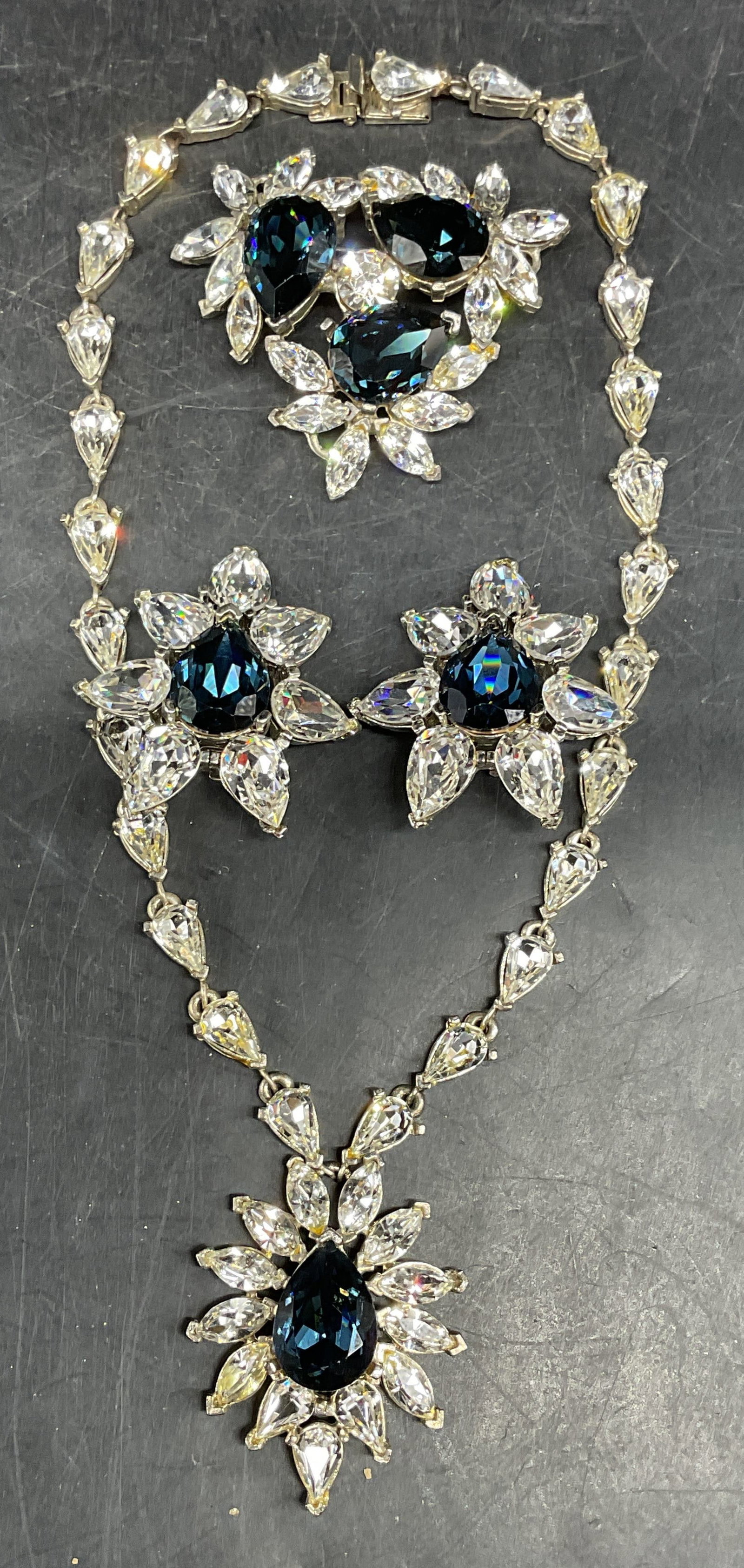 Set 3 Todd Anthony Blue Rhinestone Jewelry: Set of 3 pieces matching Todd Anthony silver tone blue and colorless rhinestone jewelry. 1 Necklace, 1 pair of earrings, and 1 brooch. Necklace drop length 7 inches. Earrings measures approx. 1.75 inc