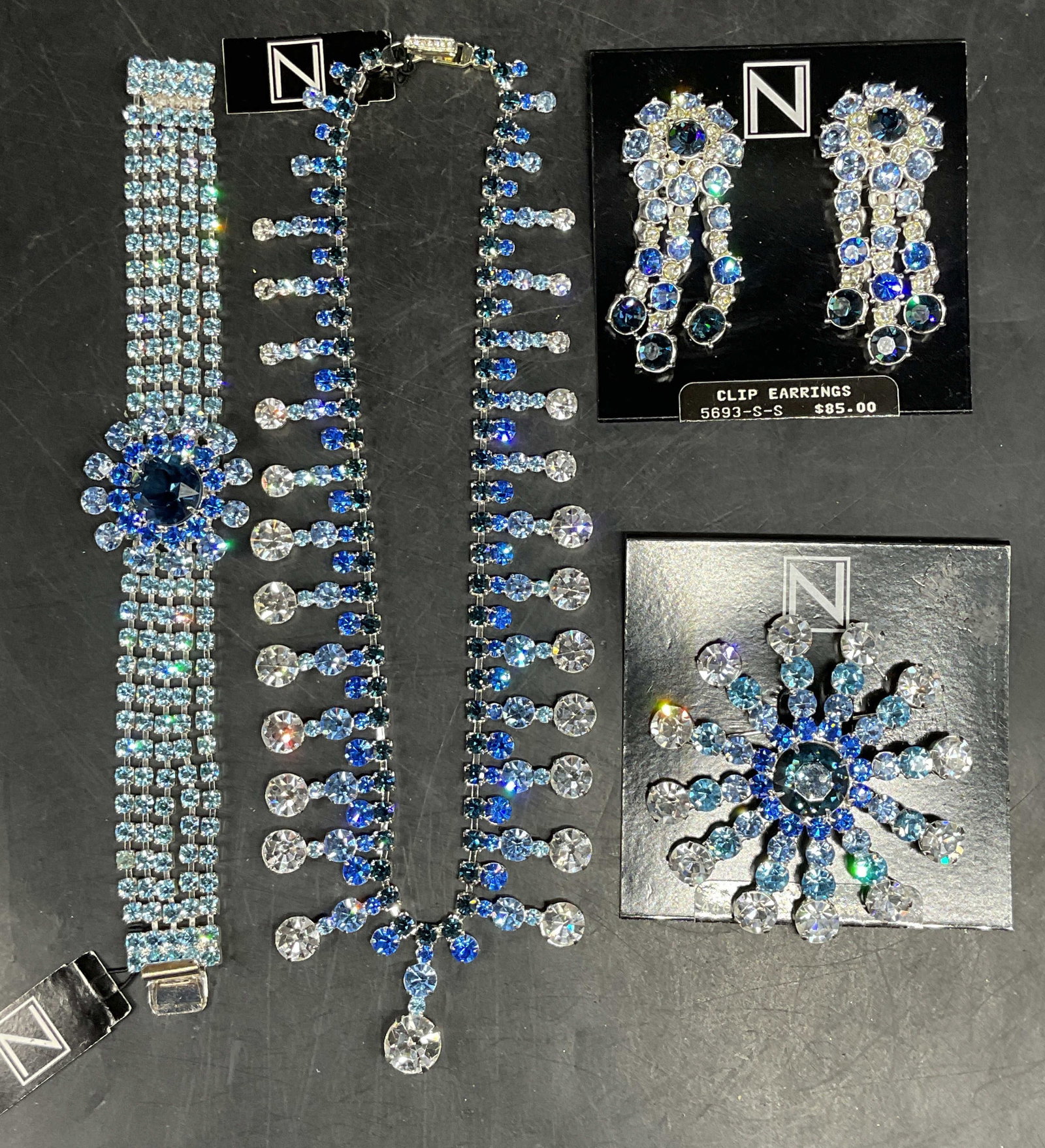 Set 4 Vintage Napier Blue Rhinestone Jewelry NWT: Set of 4 vintage matching Napier silver tone and blue rhinestone jewelry. 1 pair of earrings, 1 brooch, 1 necklace, and 1 bracelet. Necklace drop length 7 inches. Bracelet measures approx. 7 inches. B