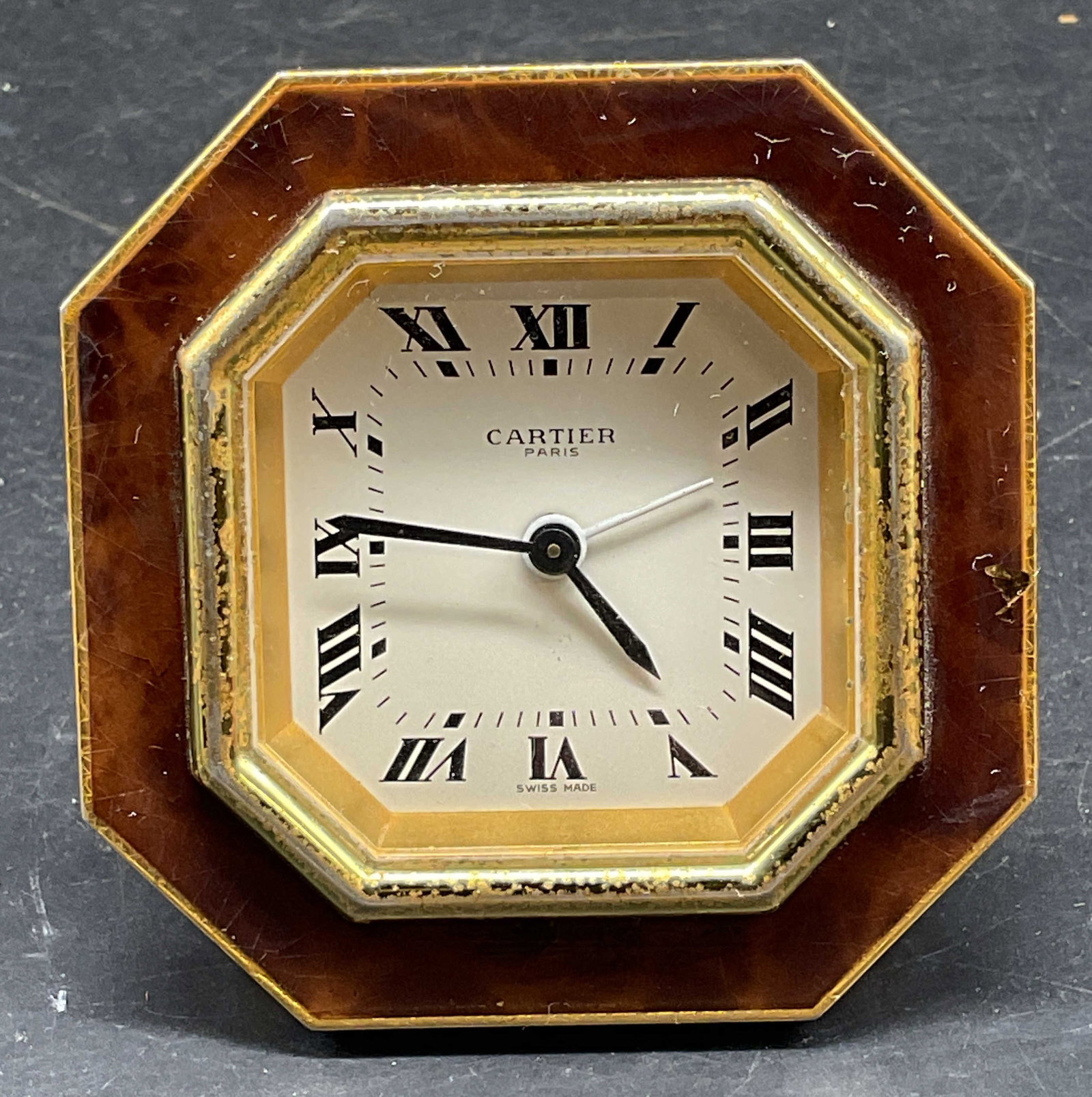 Vtg Cartier Gold Plated Desk Alarm Clock: Vintage Cartier gold plated desk alarm clock. Octagonal shaped case. Brown enamel border. Roman numeral dial. Monogram logo easel back. Swiss made. Numbered 7507 01216. Not tested. Some scratching, lo