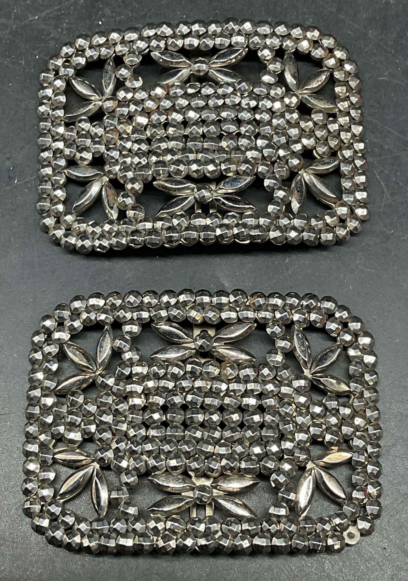 Pair Antique Cut Steel Buckles, France: Pair of antique cut steel buckles. Made in France. Geometric floral designs. Measures approx. 2.5 x 1.75 inches. Some scratching. One bead needs replacement. Antiques, collectibles, antique buckle, Fr