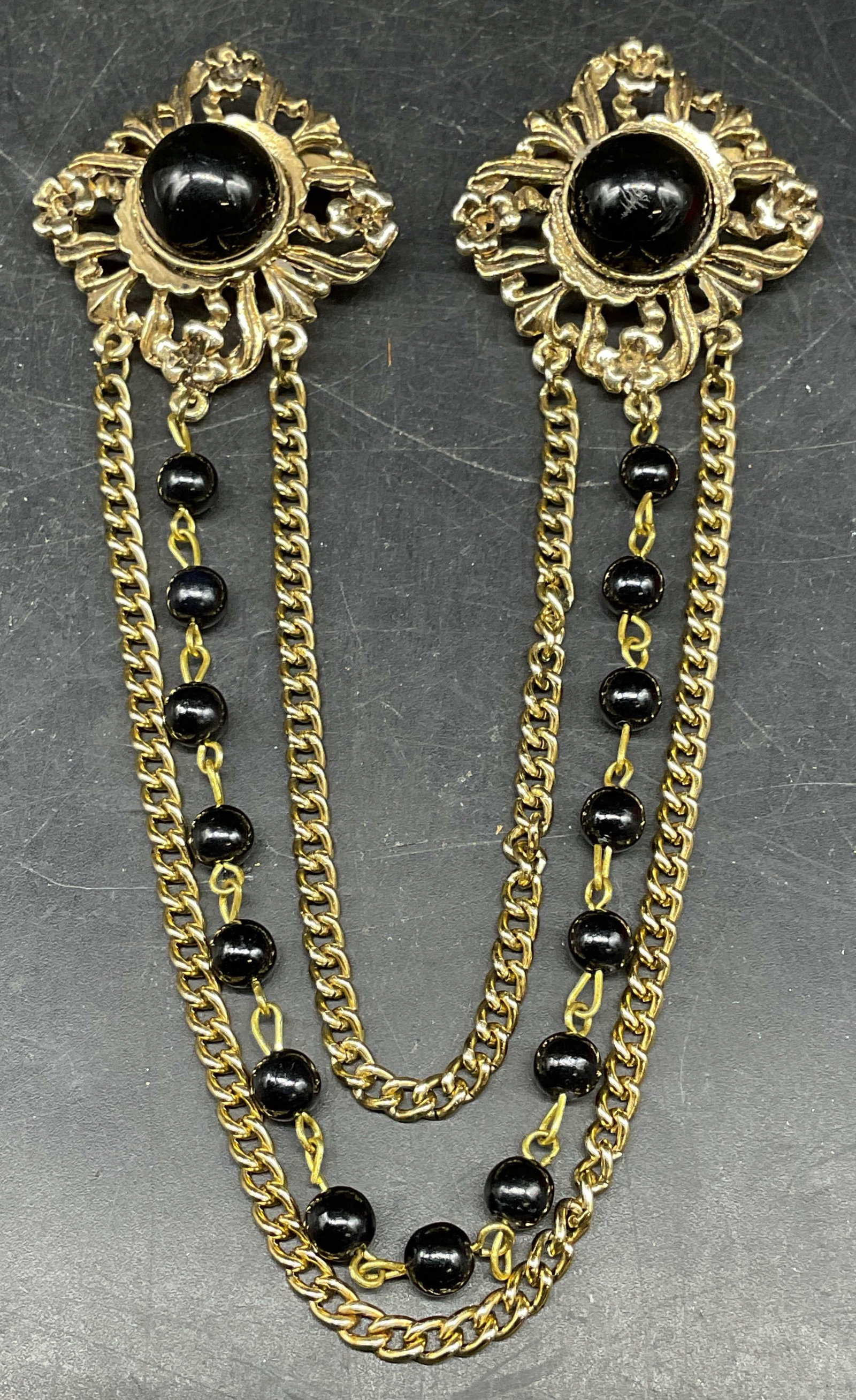 Vtg Gold Tone Black Two Piece Chain Brooch: Vintage gold tone and black lucite two piece brooch with triple chain. Brooches measures approx. 1.5 x 1.5 inches each. Some scratching. Jewelry, estate jewelry, costume jewelry, cocktail jewelry, fas