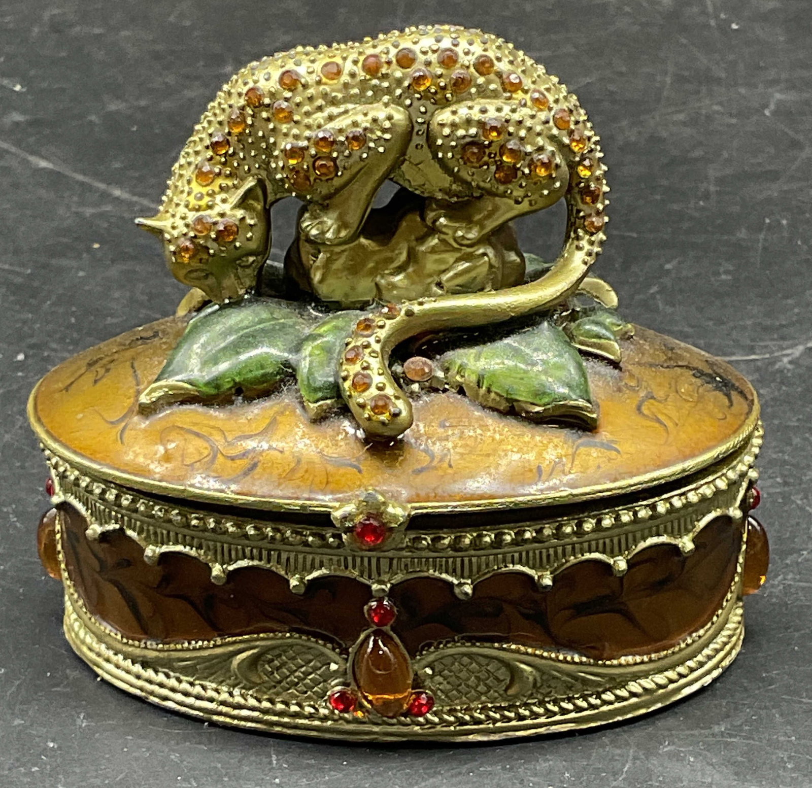 Enamel & Rhinestone Cheetah Trinket Box: Gold tone enamel and rhinestone decorated cheetah motif trinket box. Measures approx. 3 x 1.75 x 2.5 inches. Some scratching. Cheetah trinket box, enamel trinket box, home decor, home accessories, tab