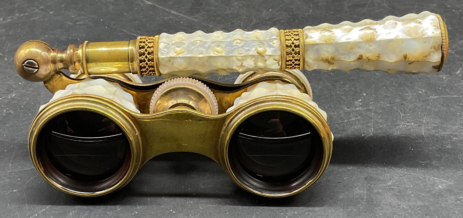 S. Desio Mother of Pearl Opera Glasses: S. Desio brass and mother of pearl opera glasses. Marked S. Desio Washington DC. Measures approx. 4 x 1.75 x 1.5 inches. Wear including scratching patina and scratching. Opera glasses, mother of pearl